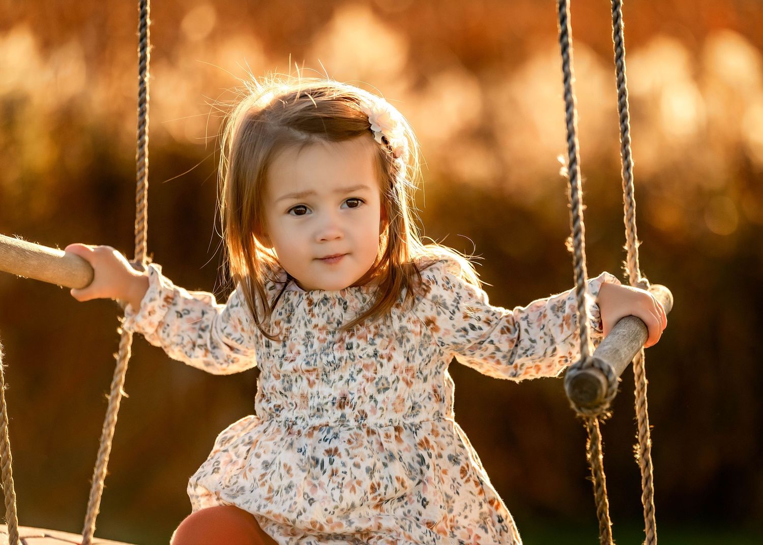 Toddler photo on a swing with country background during golden hour