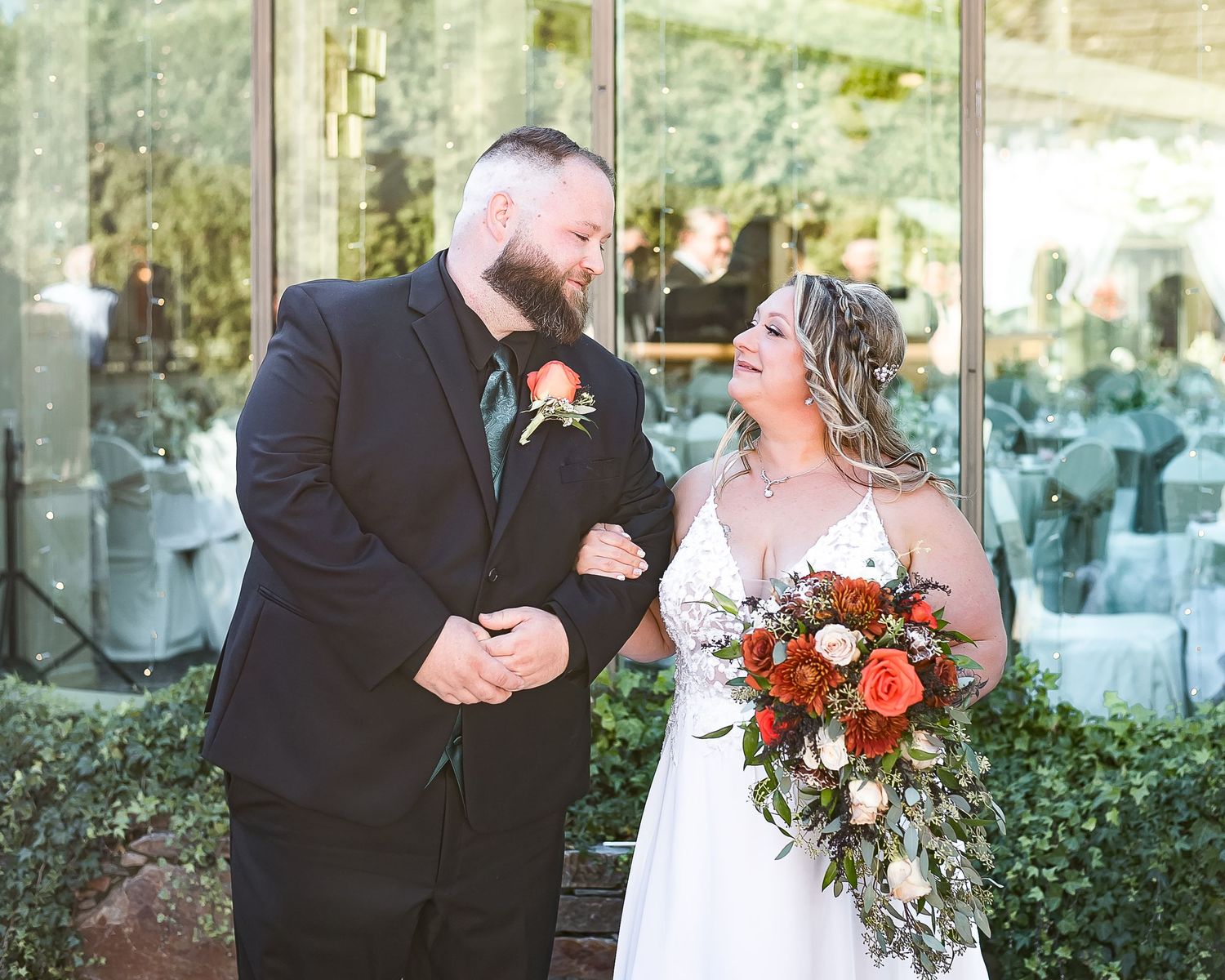 A couple smile lovingly at one another as they walk down the aisle together. Newlands Golf Course, Langley, BC.