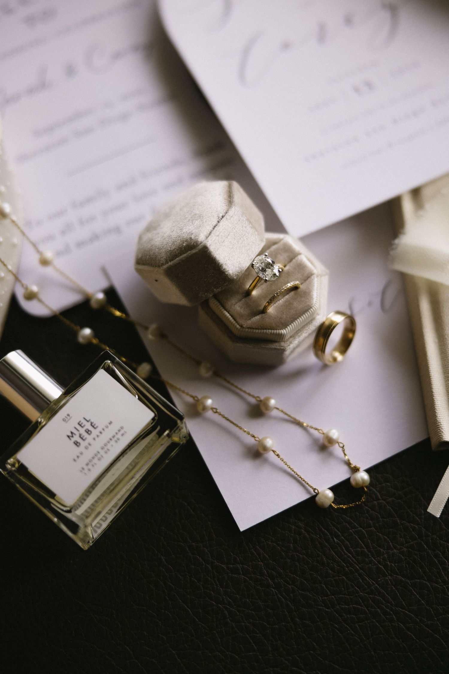 Wedding place cards and small decorative elements arranged artistically on a dark surface.