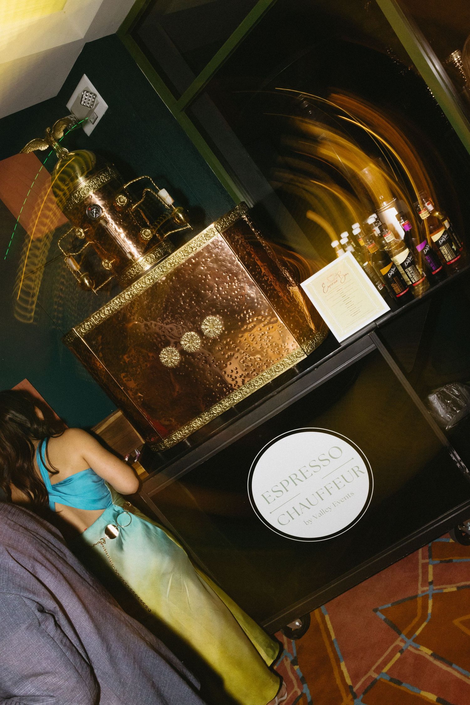 Luxury gold espresso machine displayed on a dark shelf at Chaufield, with elegant brass accents and ornate detailing.