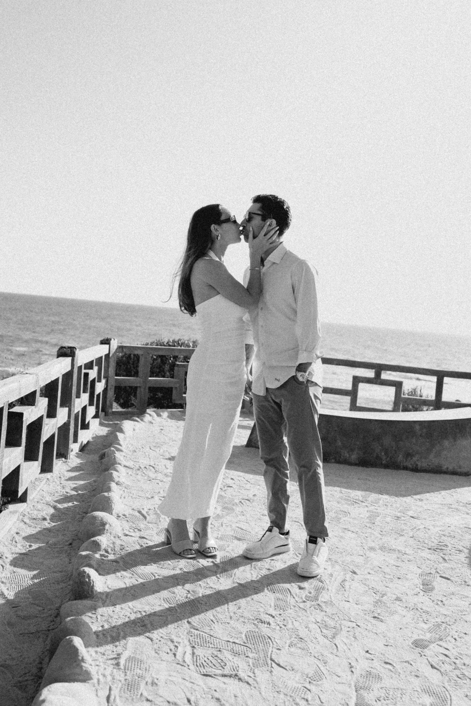 A black and white series of romantic moments on a coastal overlook.