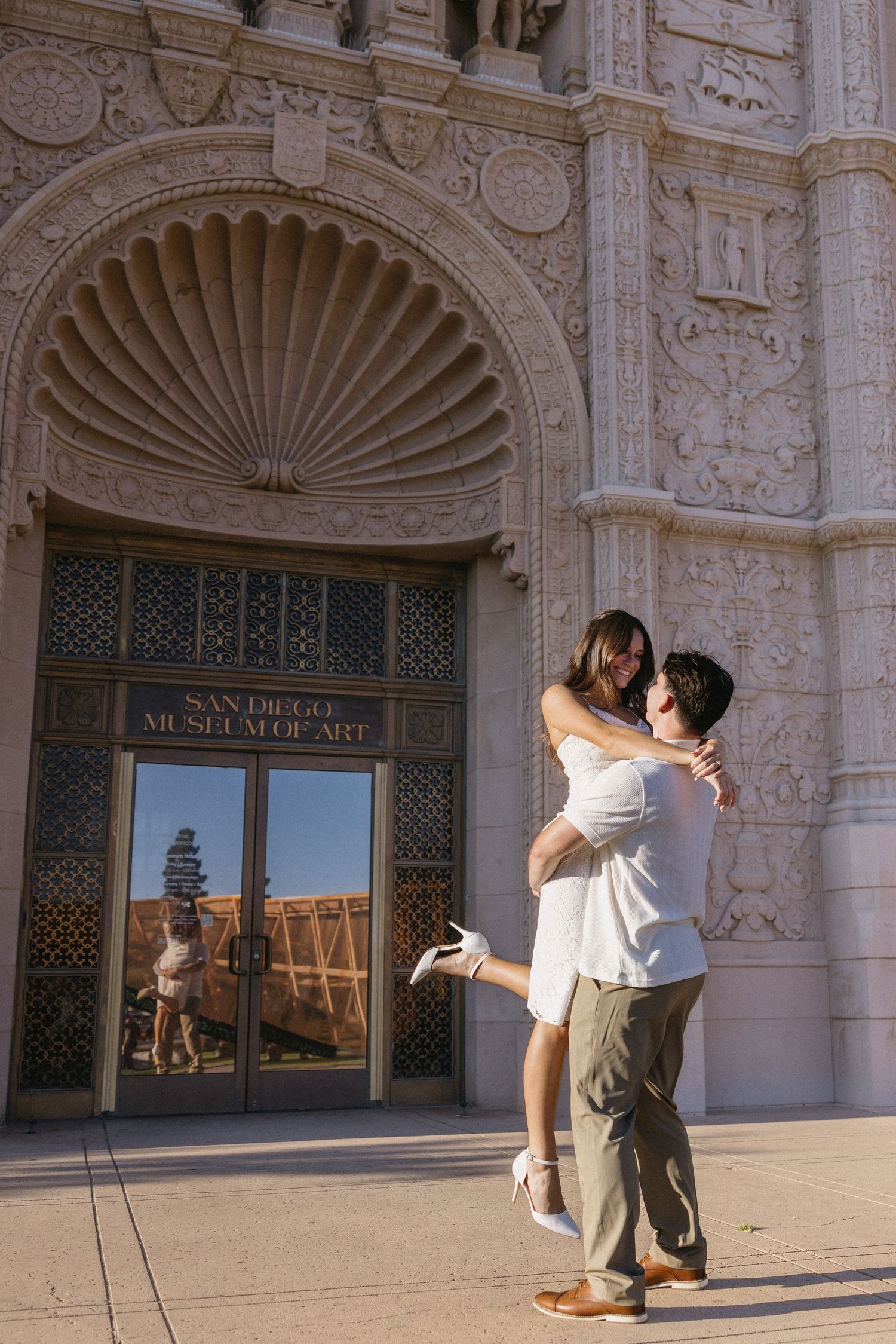 Ornate Spanish colonial architecture with decorative stone carvings and archways at San Diego Museum of Art.