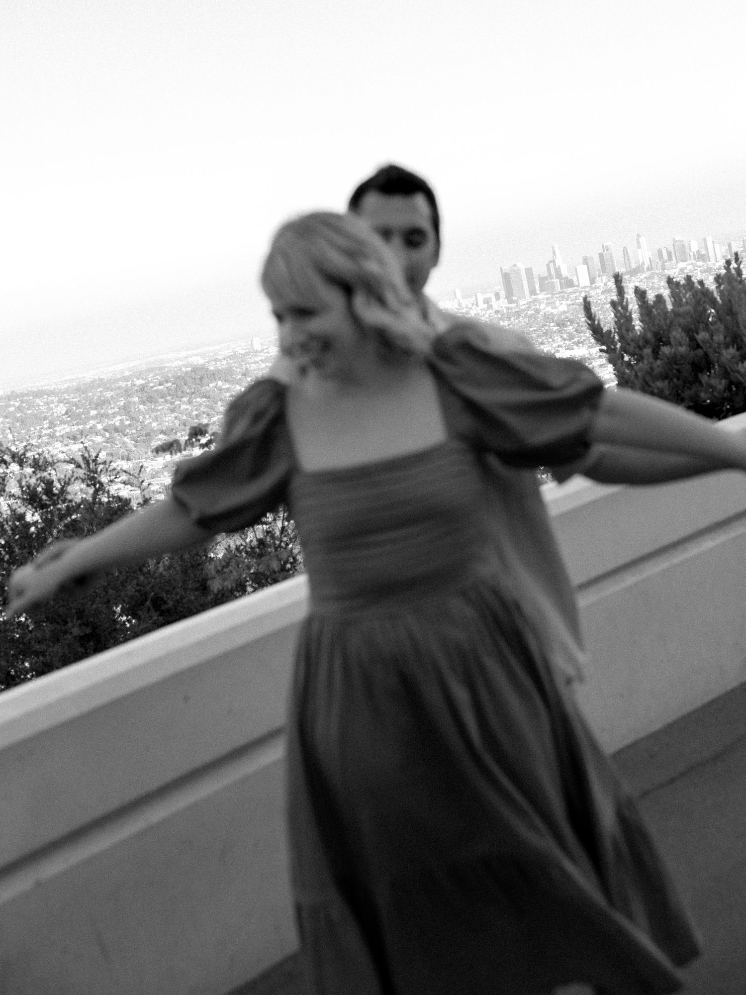 Artistic black and white sequence of dancing movements on an outdoor terrace.