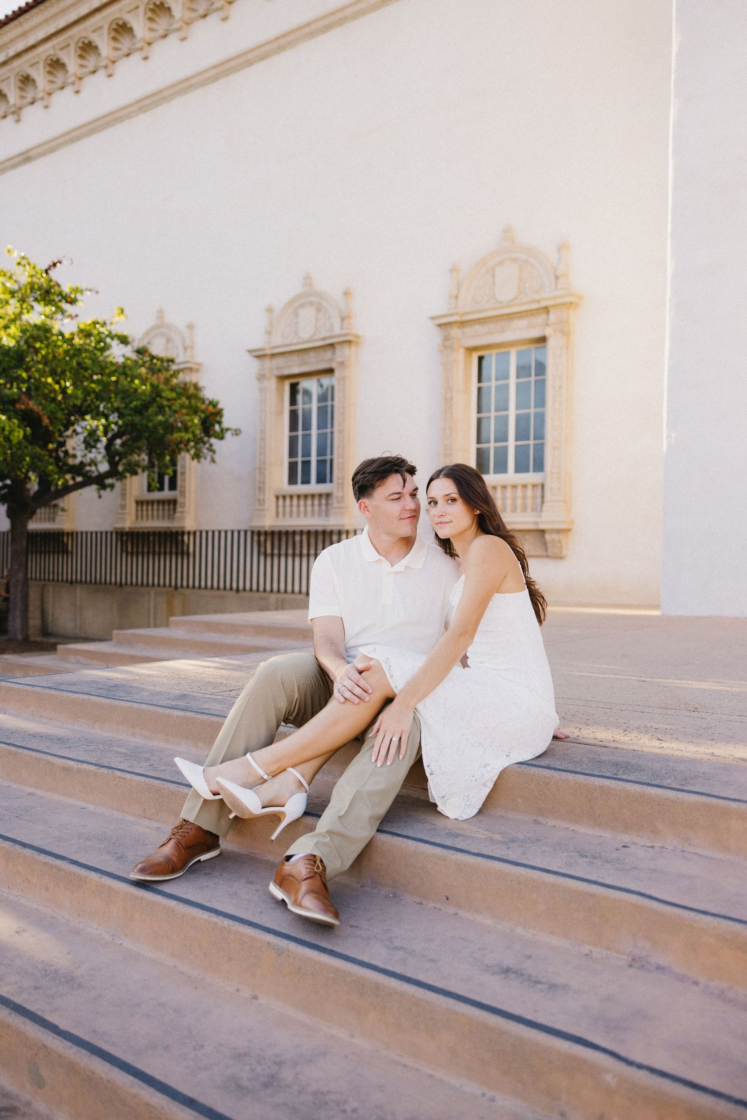 Elegant stone steps leading to a Spanish colonial style building with decorative windows.
