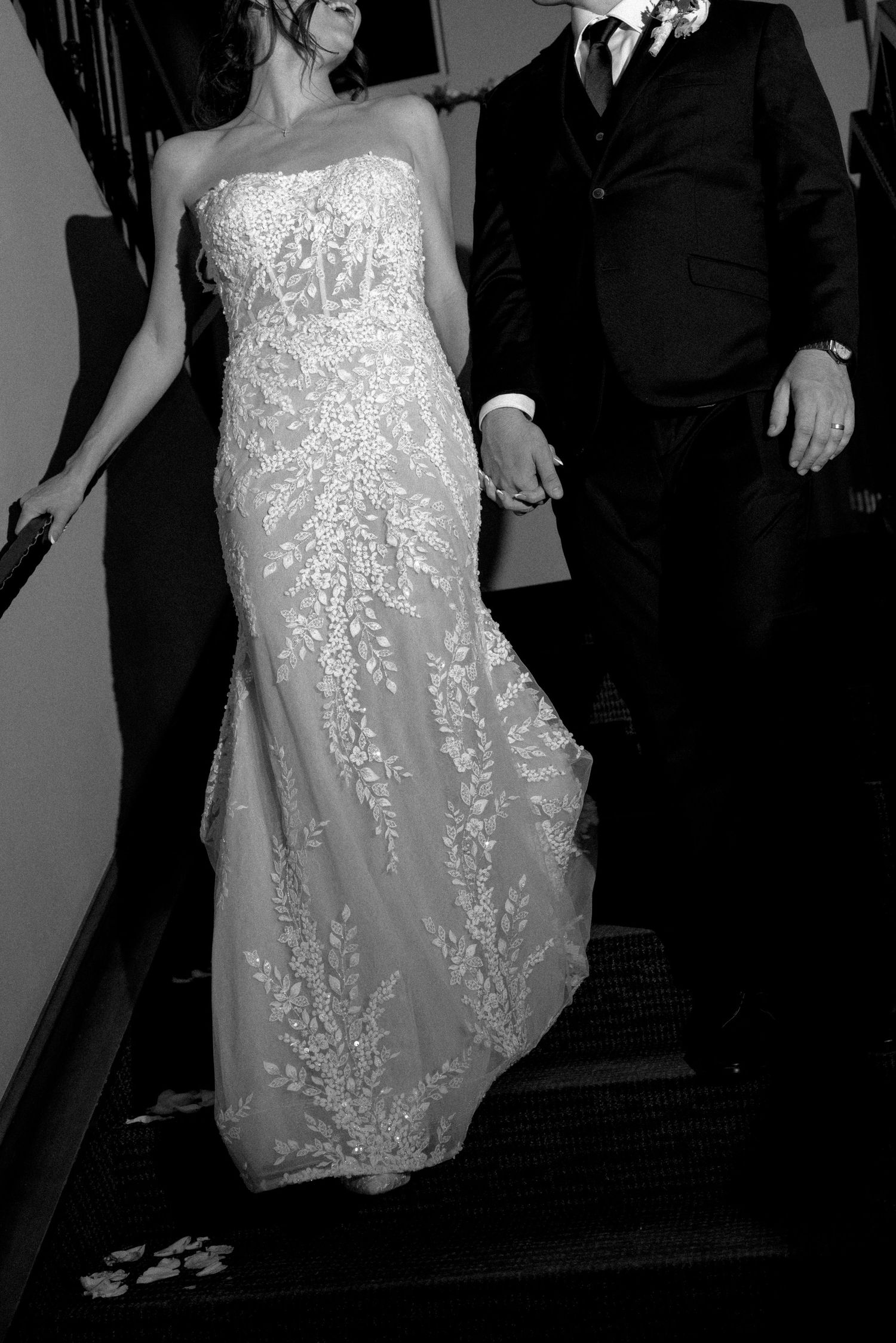 A bride in a sparkly white dress dances with her partner during a wedding celebration.
