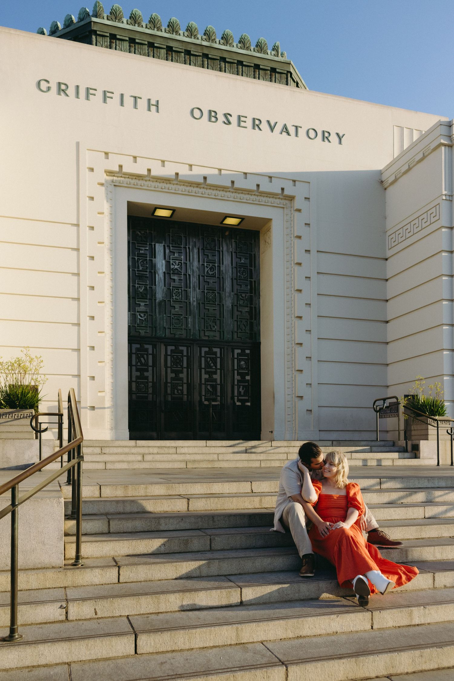 Series of romantic poses on the steps of Griffith Observatory at sunset.