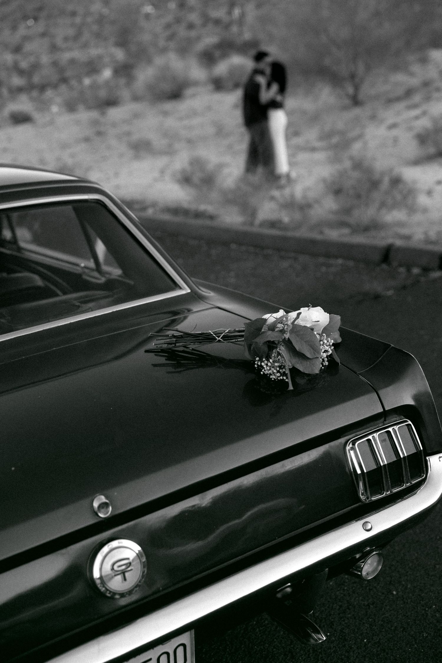 Close-up details of classic black car with decorative elements.