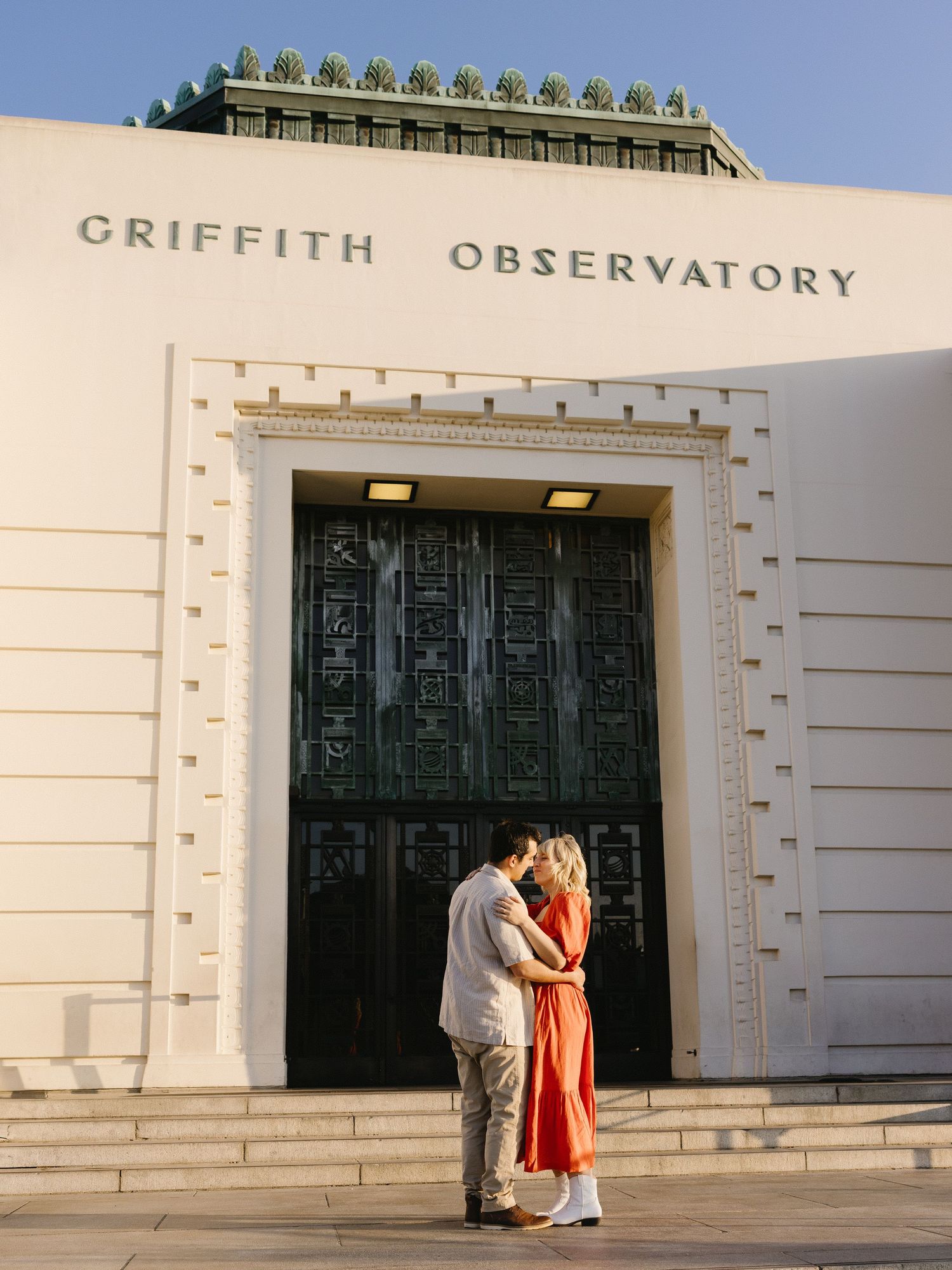 Romantic sequence at the entrance of Griffith Observatory during golden hour.