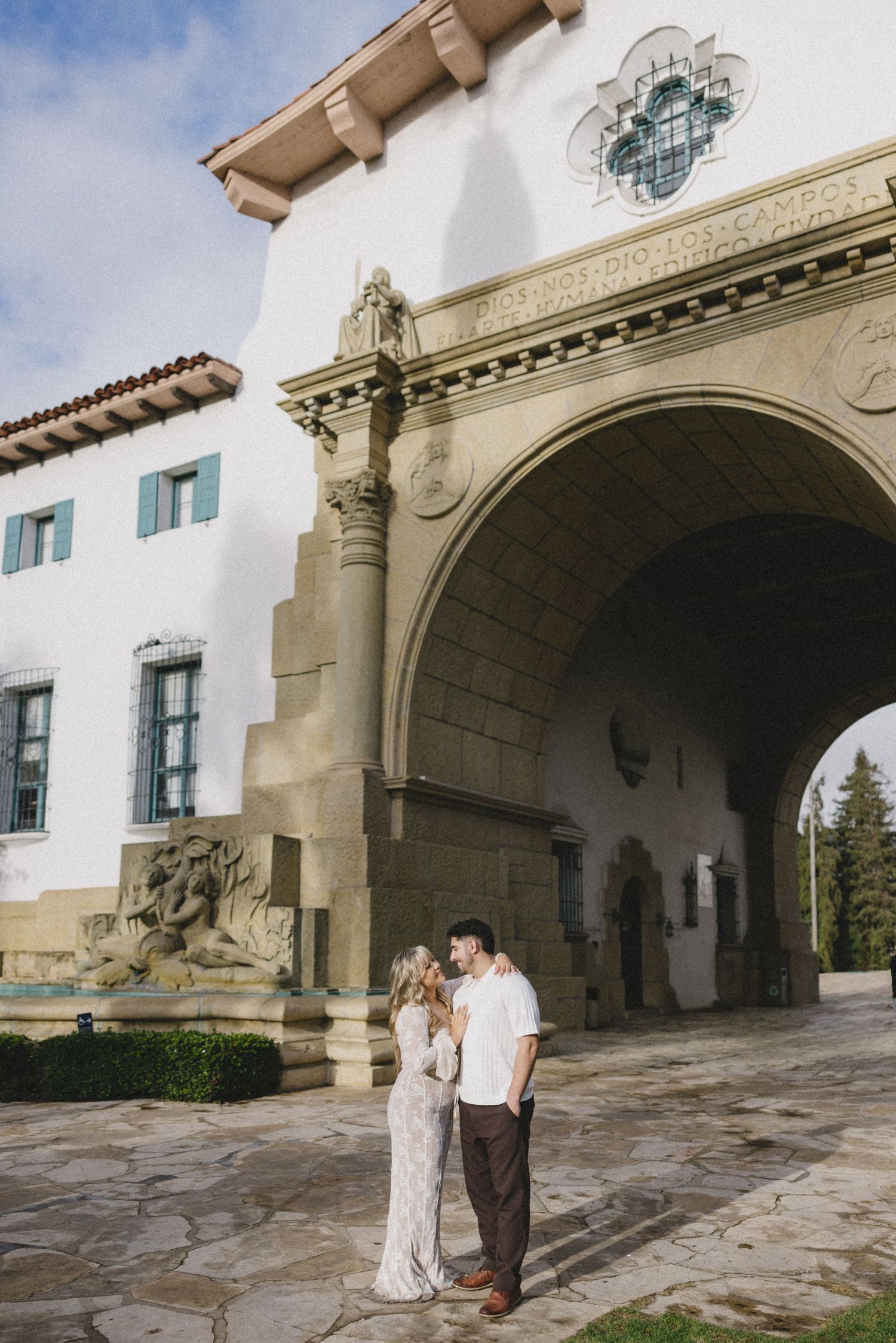 A sequence of romantic moments captured under Spanish colonial architecture with stone arches.