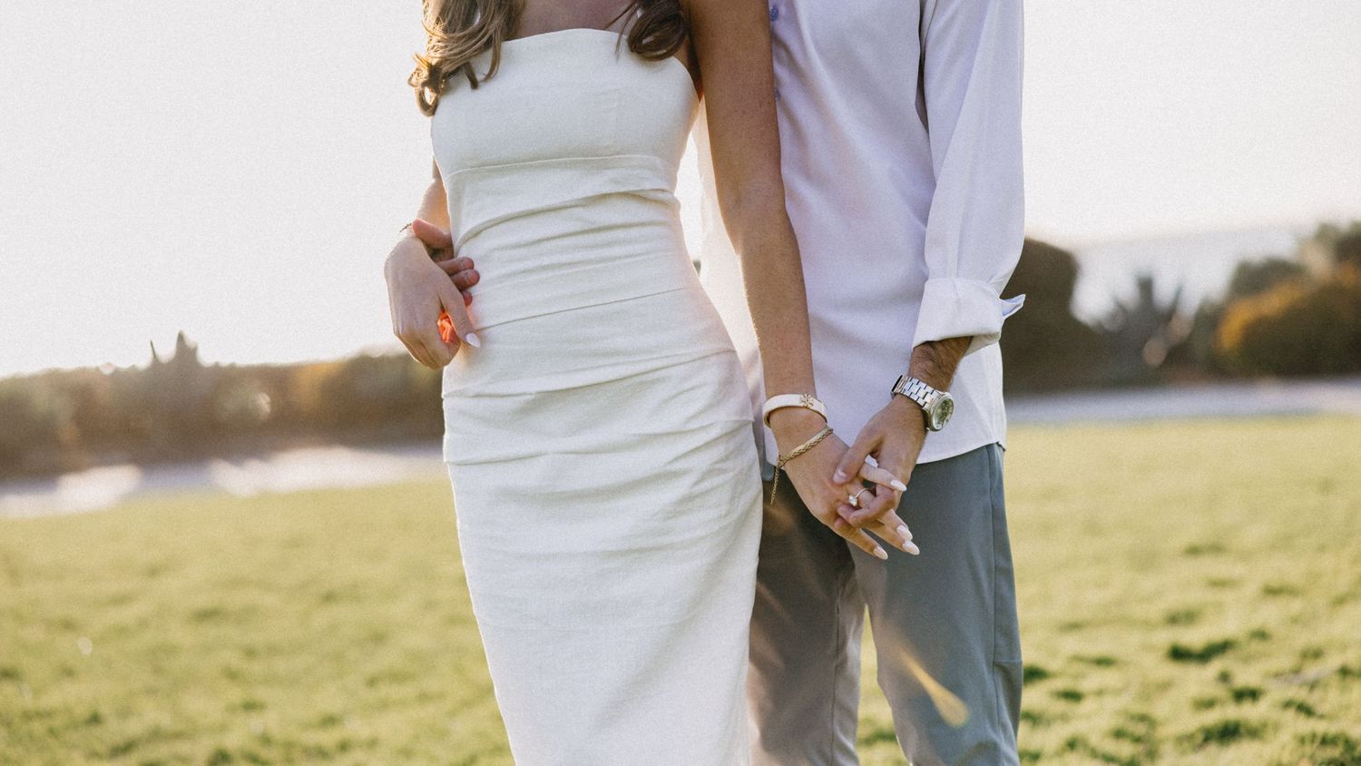 Romantic couple photos in white attire against a natural outdoor setting.
