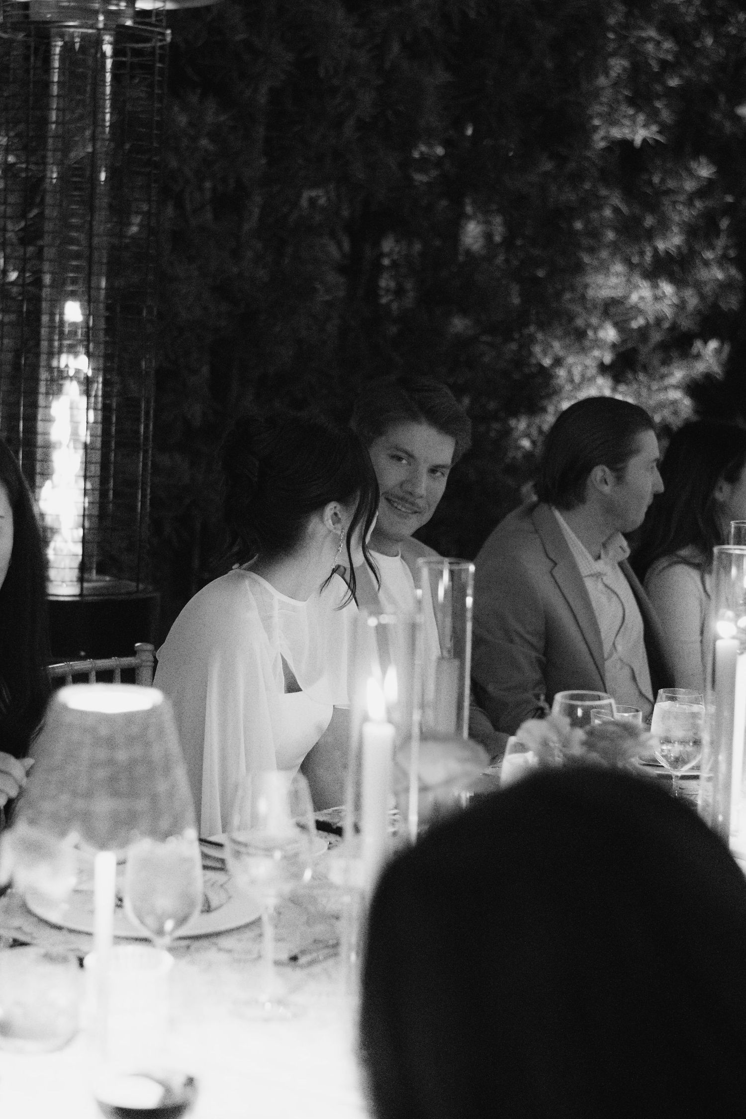 Candlelit dinner table at an elegant black and white wedding reception.