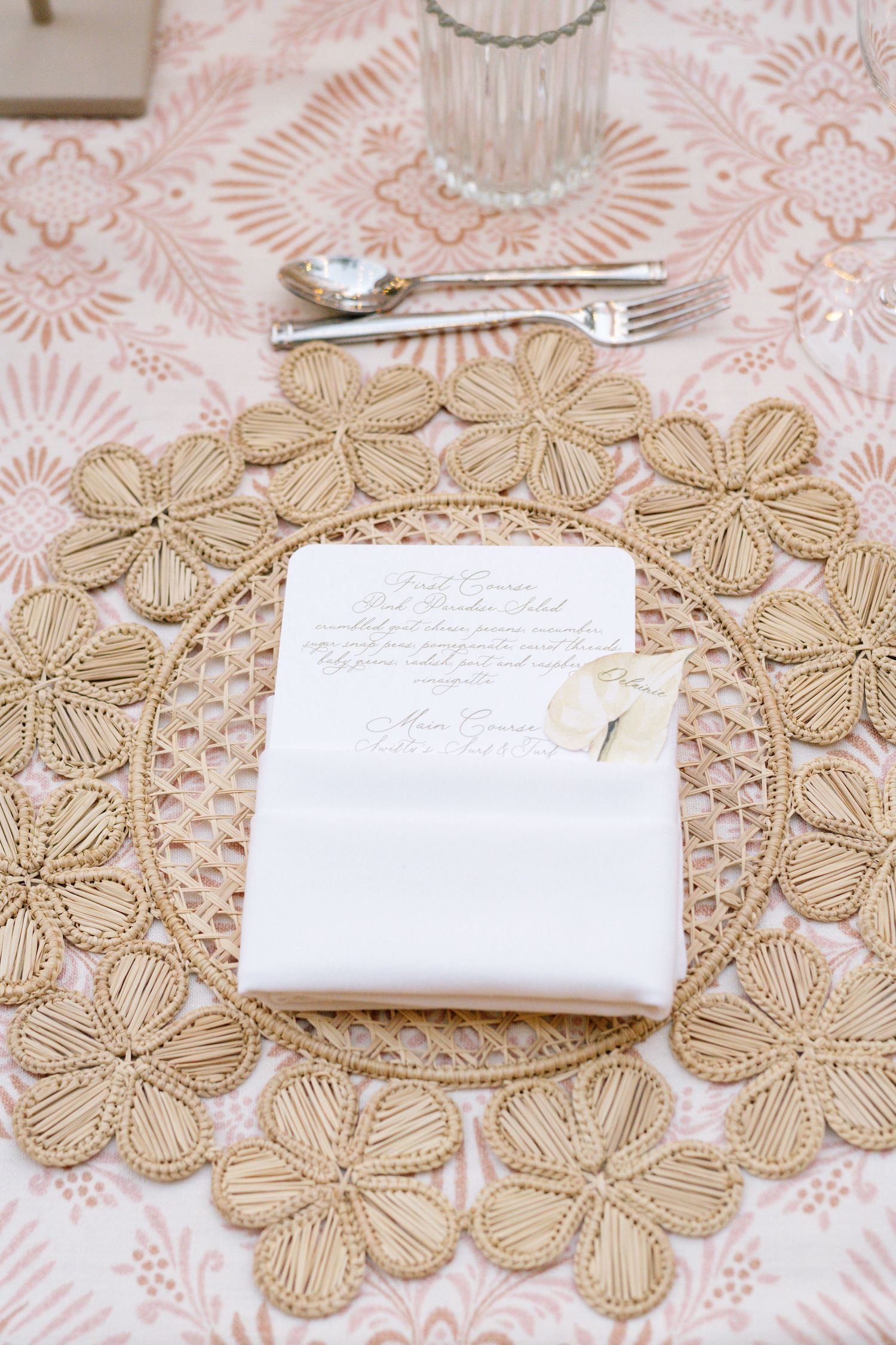 Place setting with delicate lace tablecloth and white napkin featuring handwritten note.