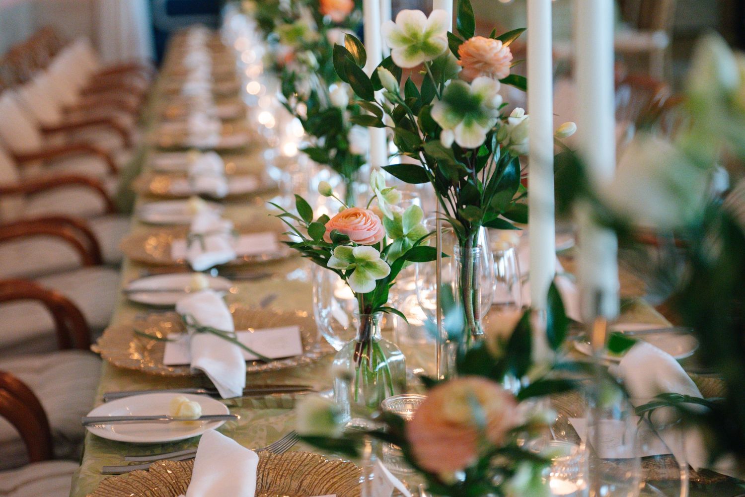 Wedding table settings with delicate floral centerpieces and place settings.