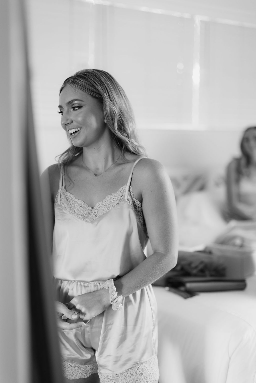 Black and white candid getting ready moments in white silk attire.