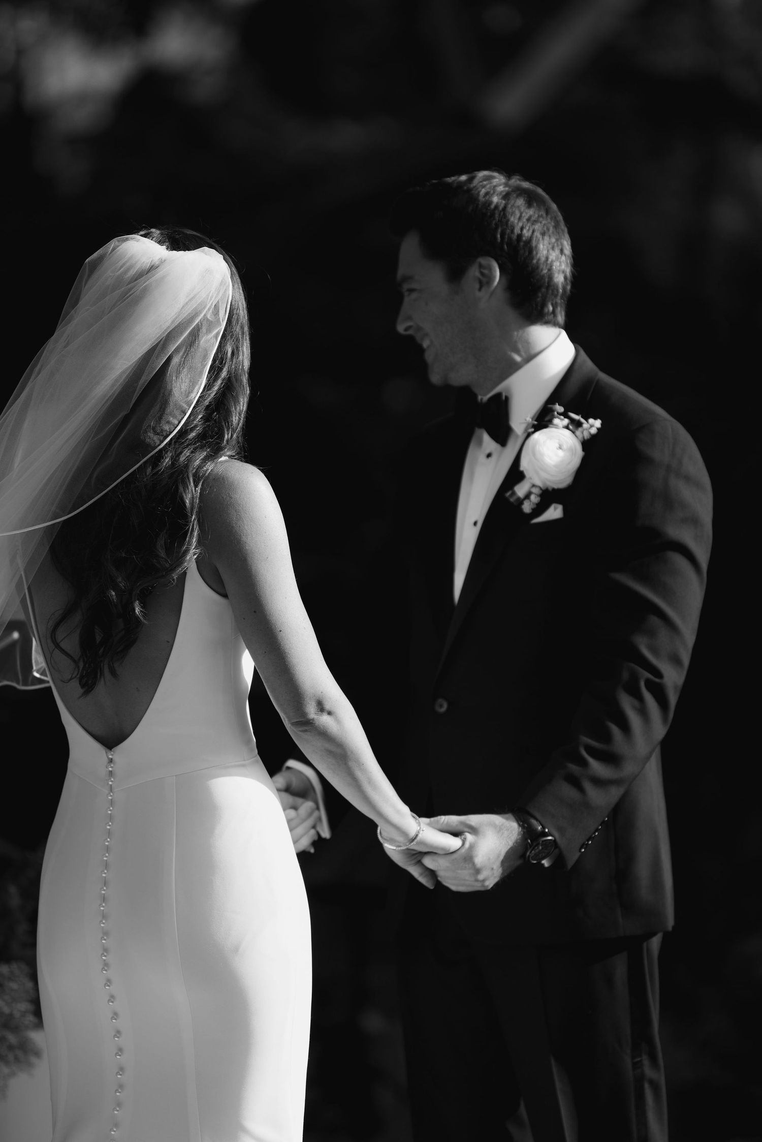 Black and white artistic detail shots of a bride and groom during their wedding ceremony.
