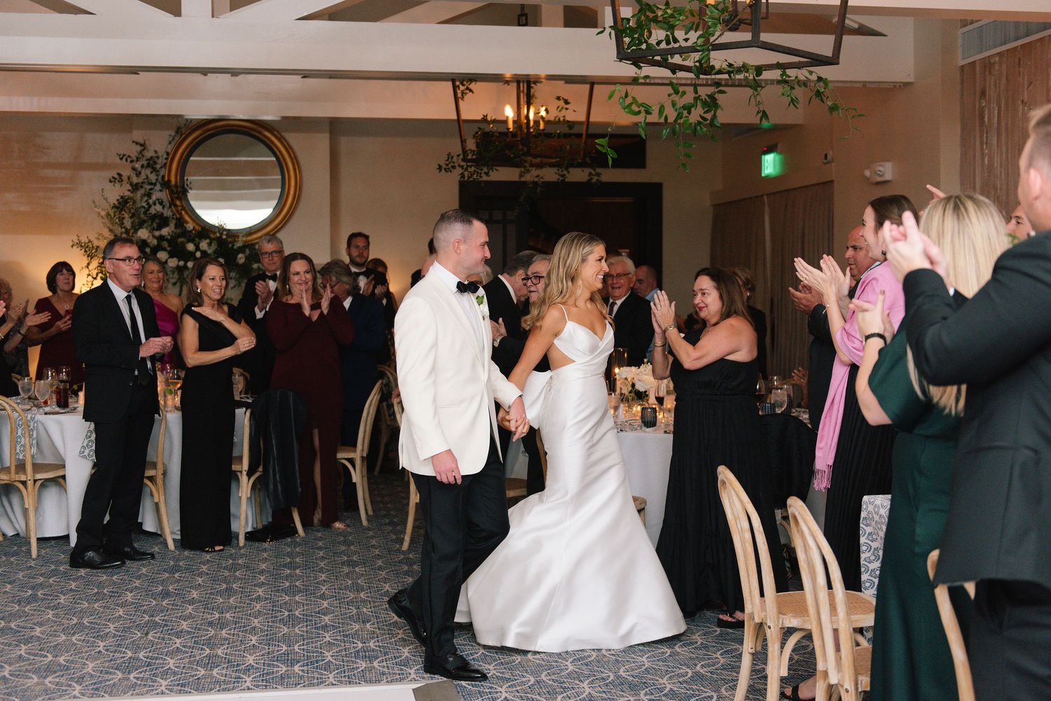 Wedding reception venue with guests dancing and celebrating on a crowded dance floor.