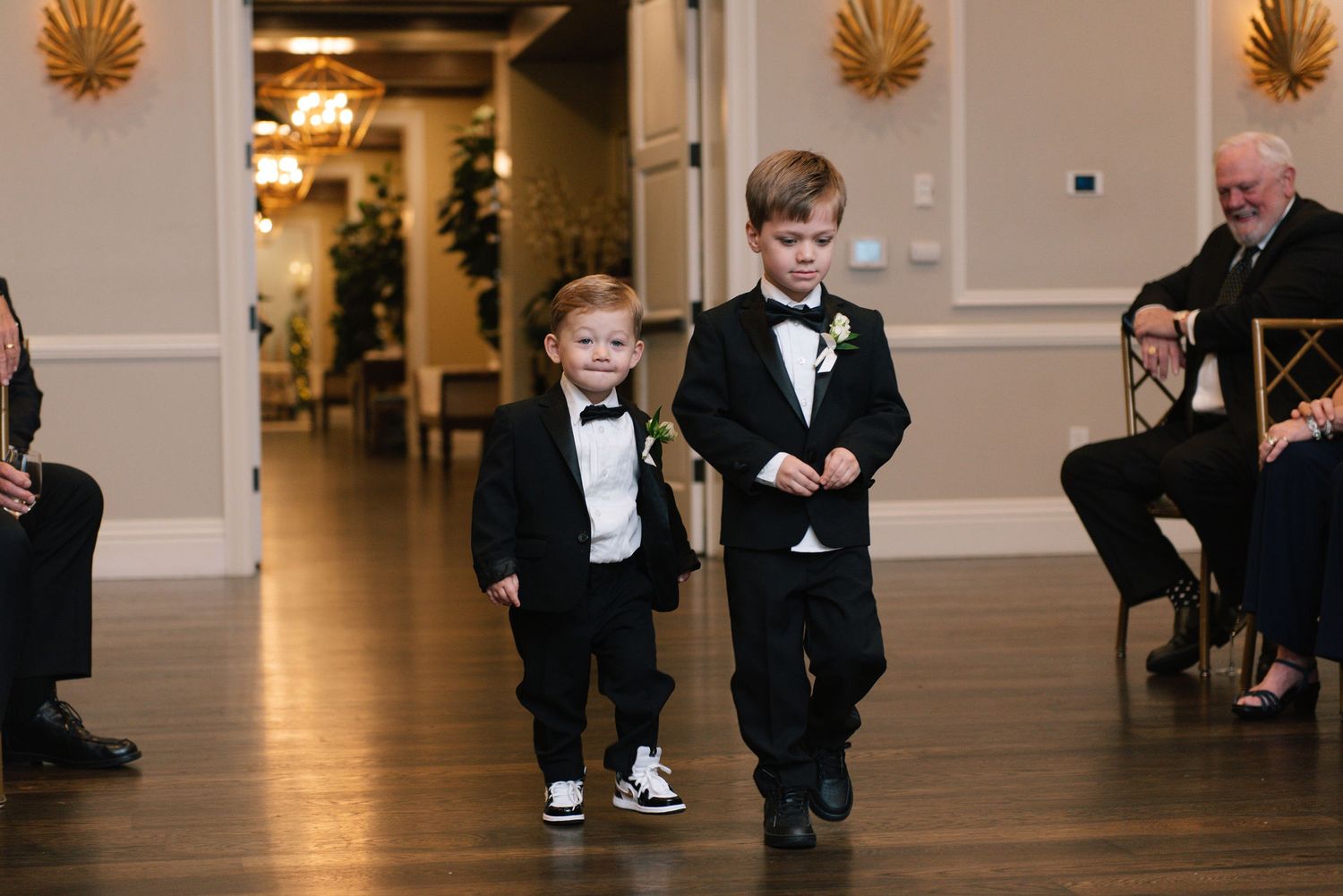 Wedding celebration in a classic ballroom with formal attire.