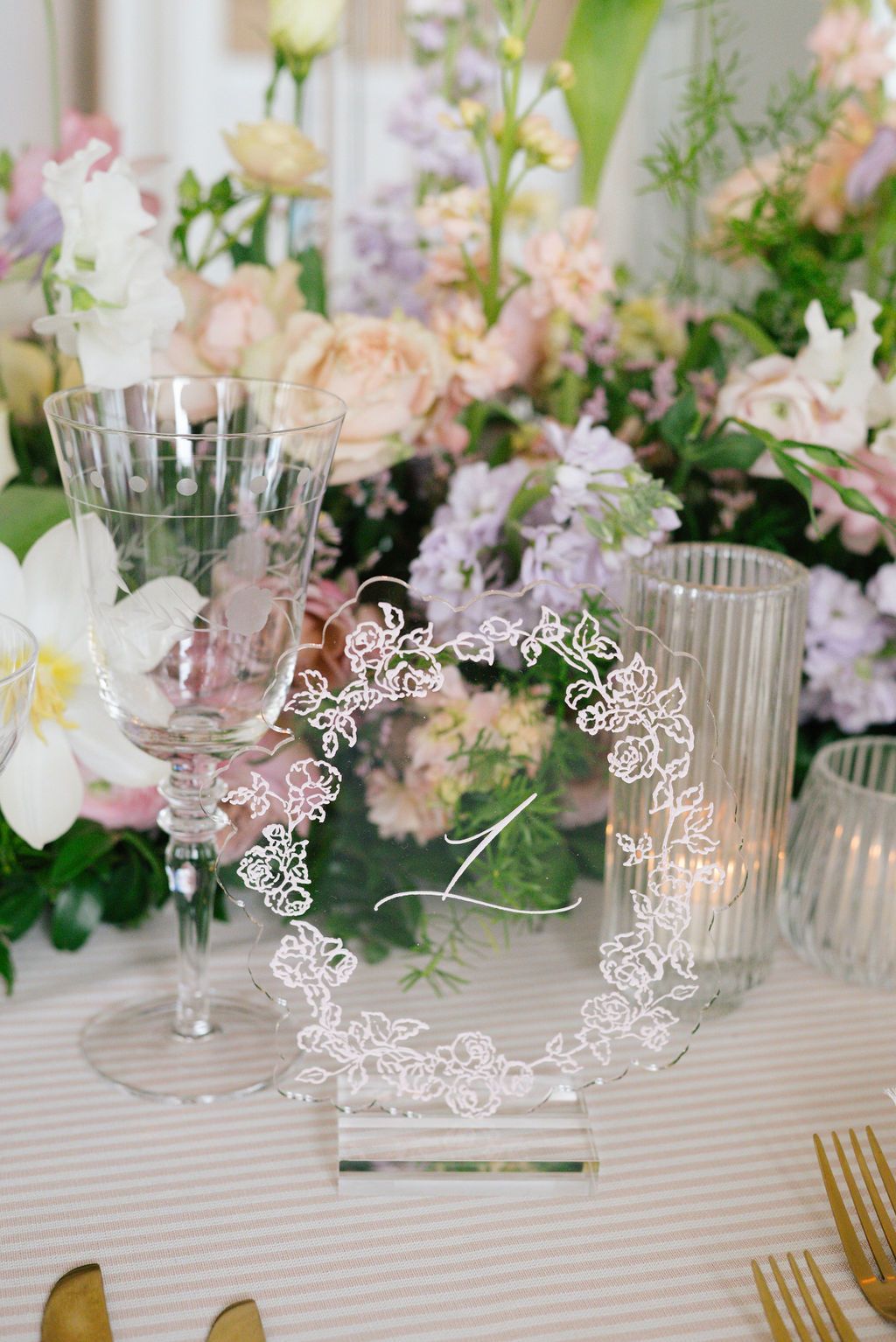 Crystal glassware and delicate butterfly decorations on an elegant table setting.