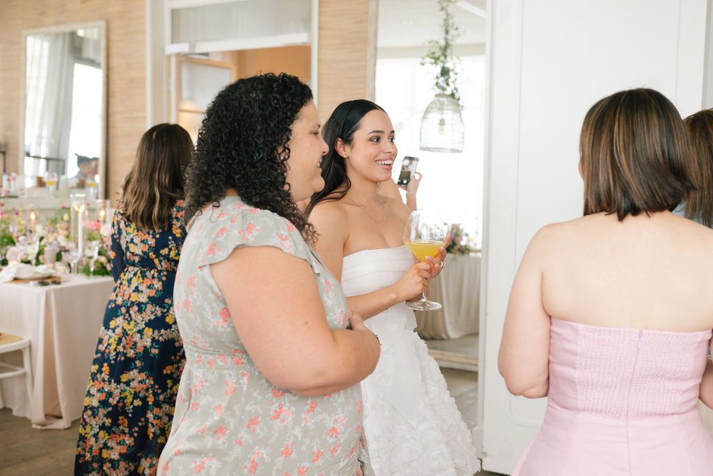 Candid moments captured during a spring brunch celebration with guests in pastel attire.