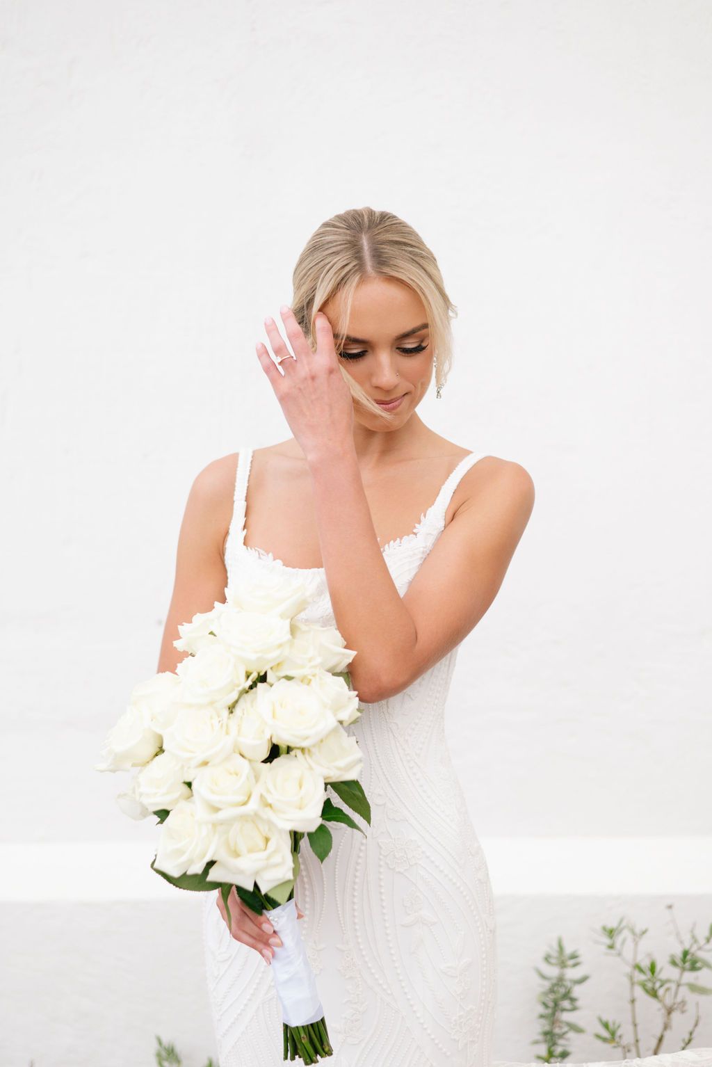 Bridal portrait series with white bouquet against clean white background.