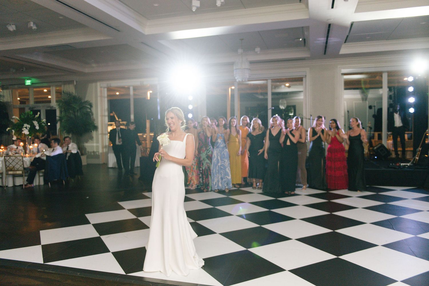 Black and white checkered dance floor in a modern wedding reception venue.