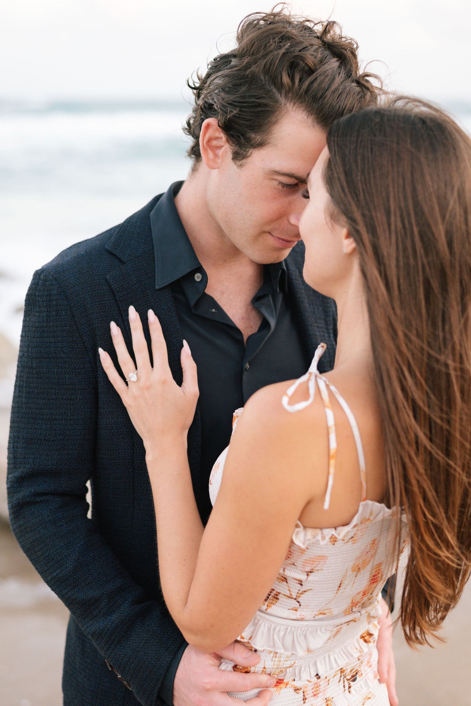 Couple in love sharing sweet moments on a bright sunny day by the beach.