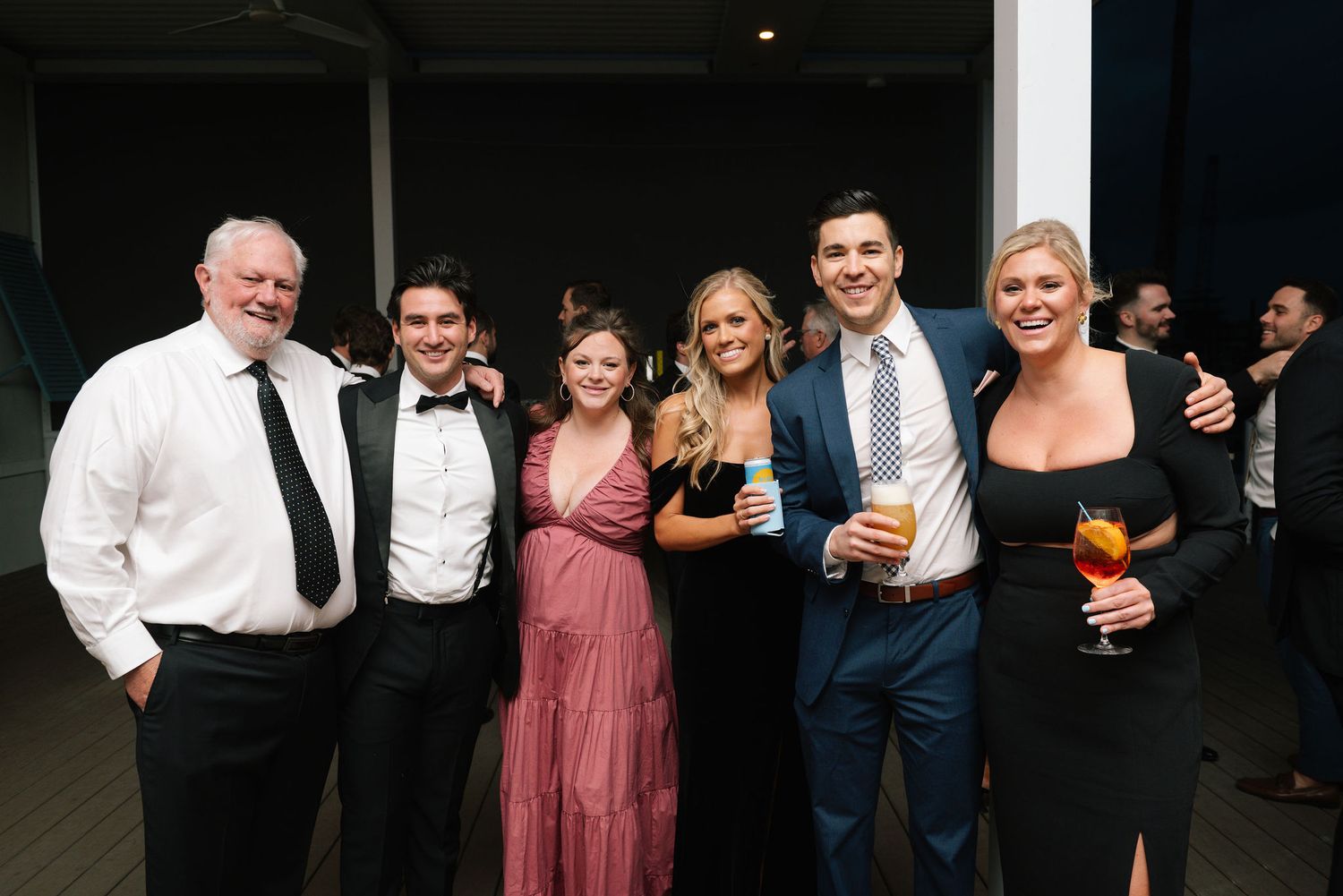 Wedding reception guests mingling and socializing at an evening event.