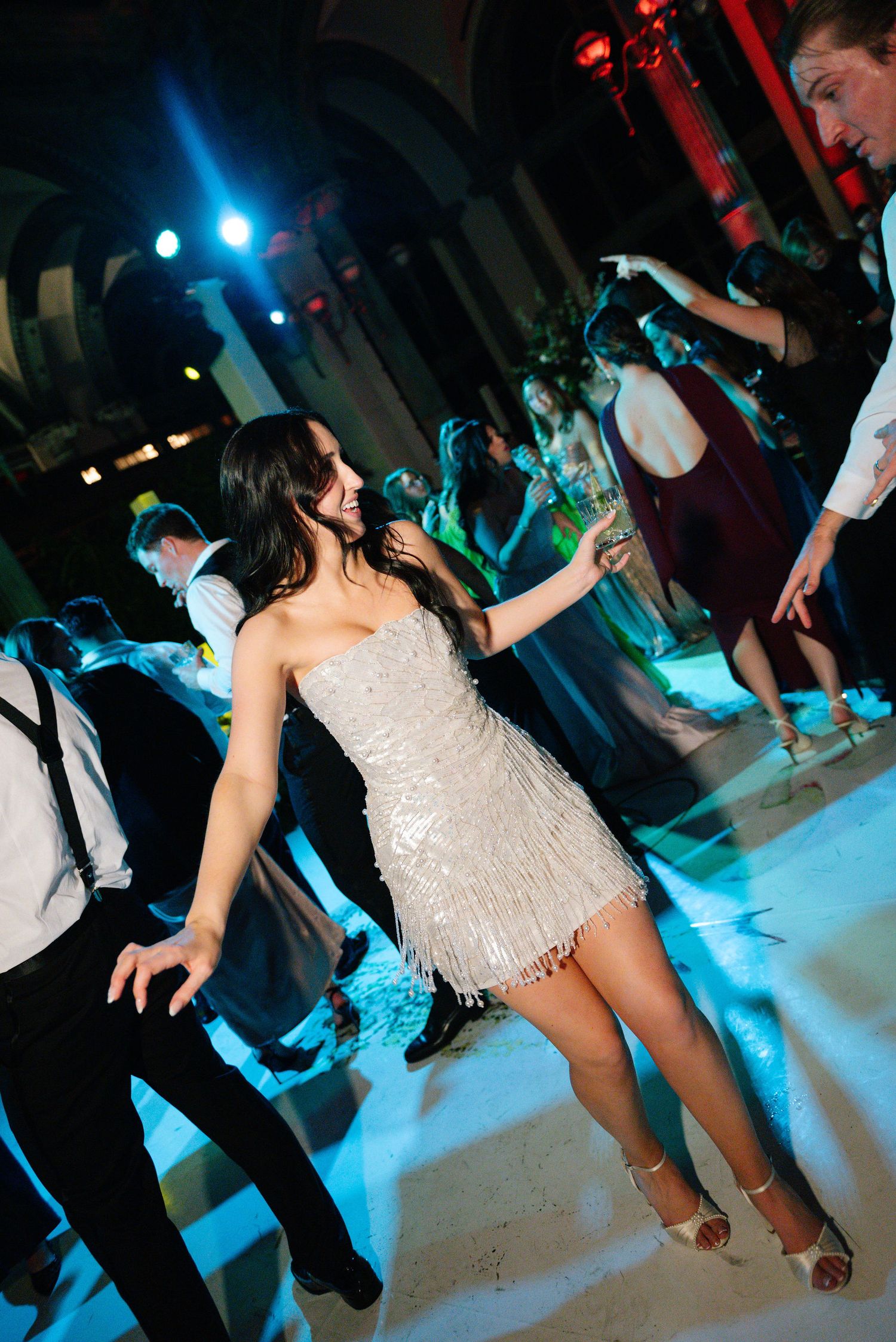 Dance floor scene with blue and red lighting effects at an elegant wedding reception.
