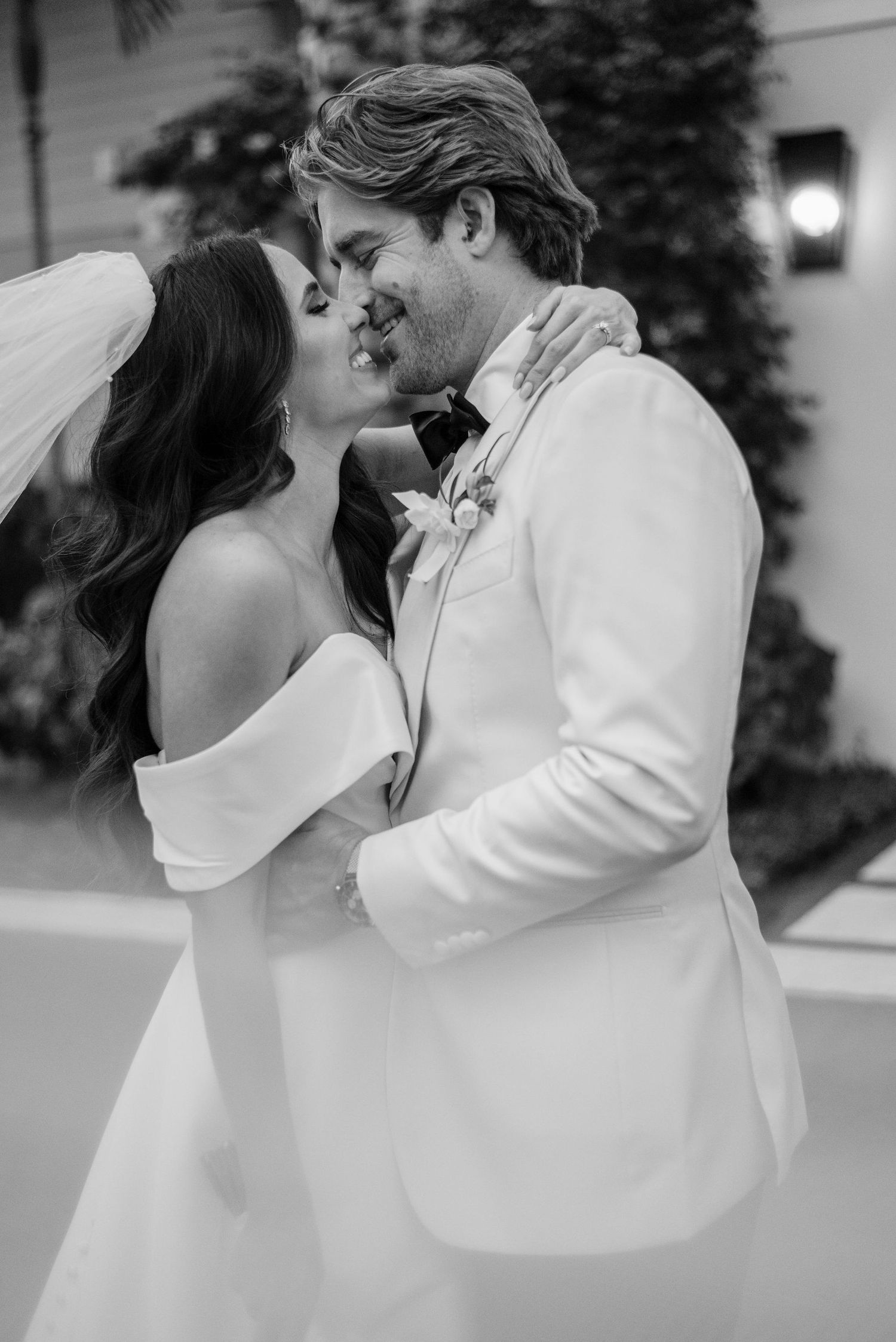 An intimate black and white wedding portrait capturing a tender moment.