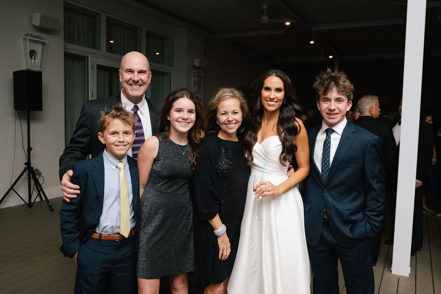 Evening wedding reception gathering with guests in formal attire.