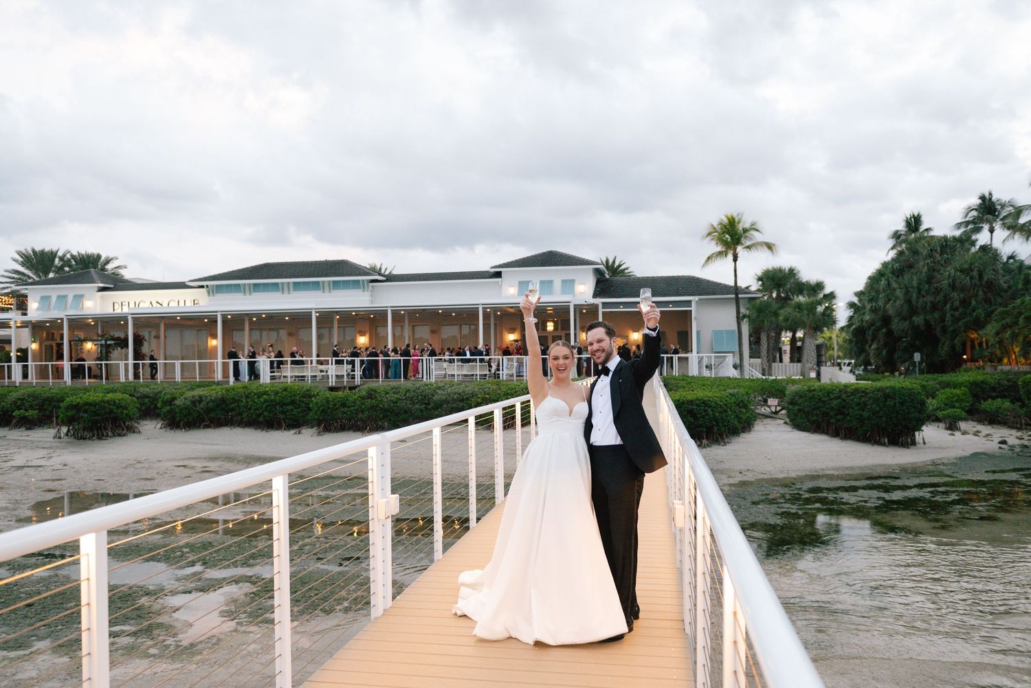 Waterfront wedding venue with wooden boardwalk and coastal views on an overcast day.