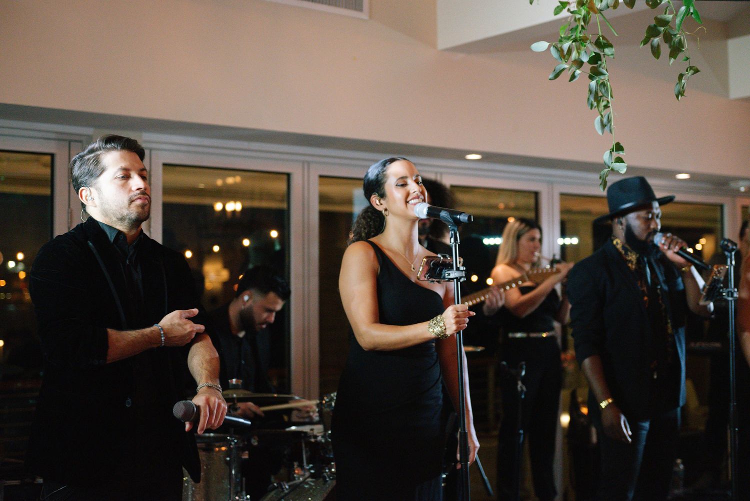 Dark reception hall with guests dancing and mingling during an evening celebration.