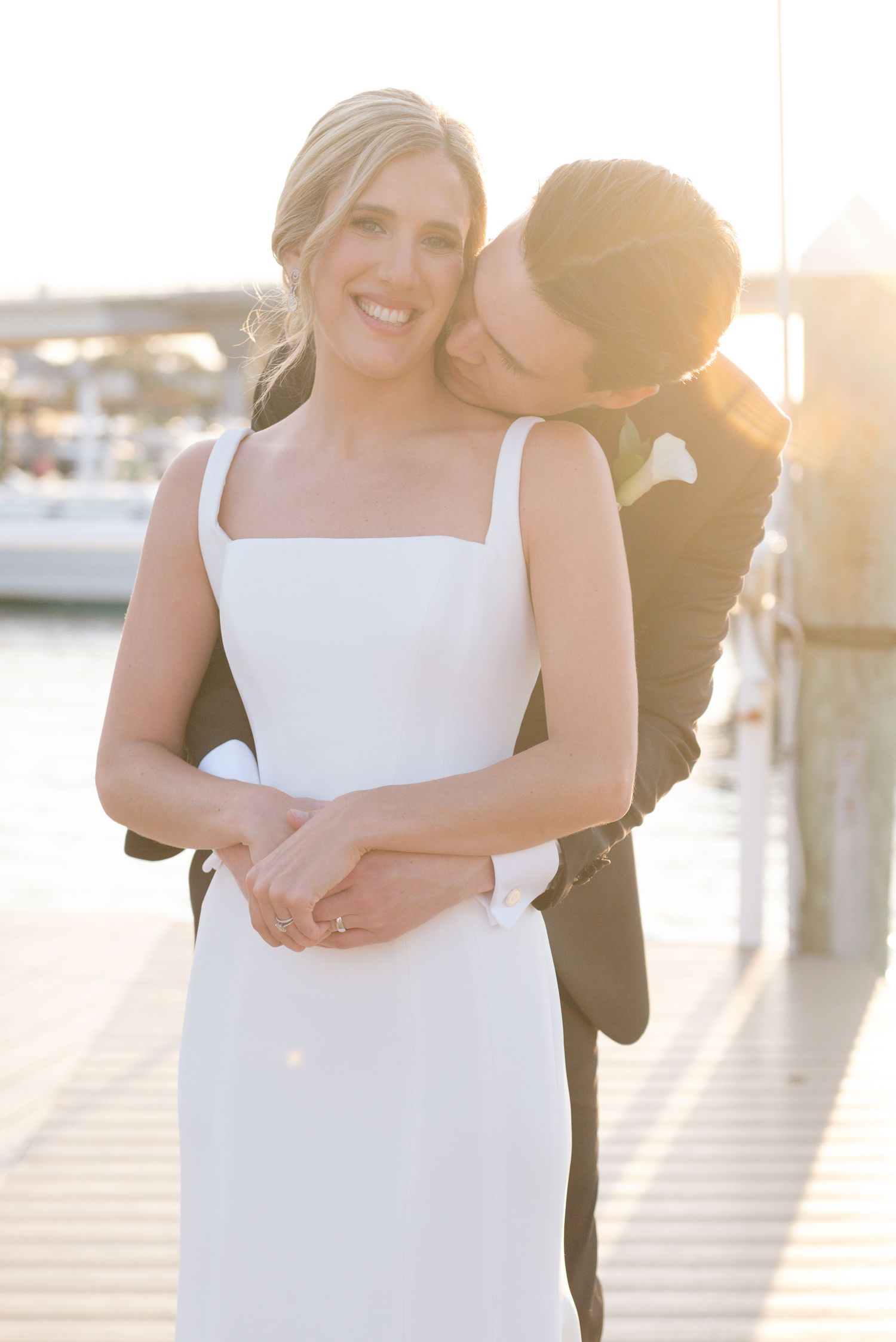 Romantic sunset portraits of newlyweds by the waterfront.