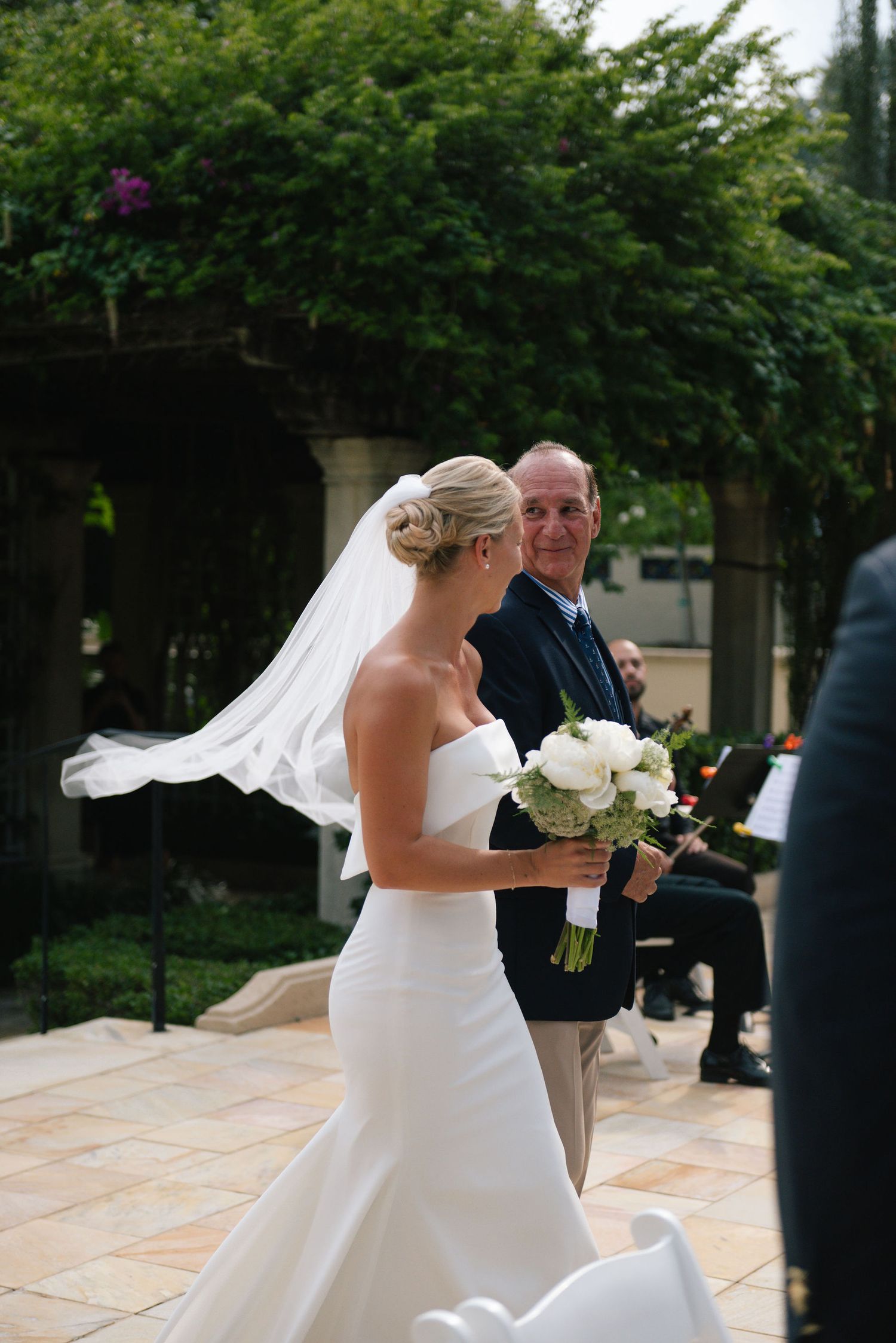 A wedding ceremony moment captured in a beautiful garden setting.