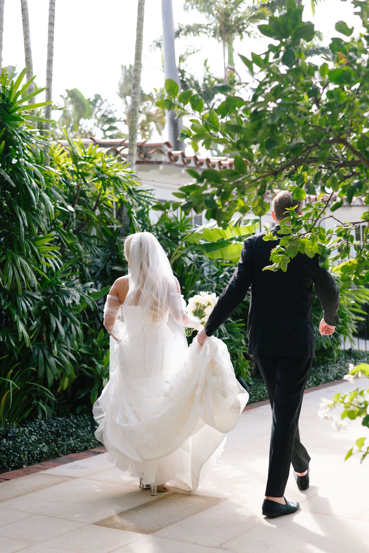 A sequence of wedding photos showing a bride in a flowing white dress walking down a palm-lined pathway.