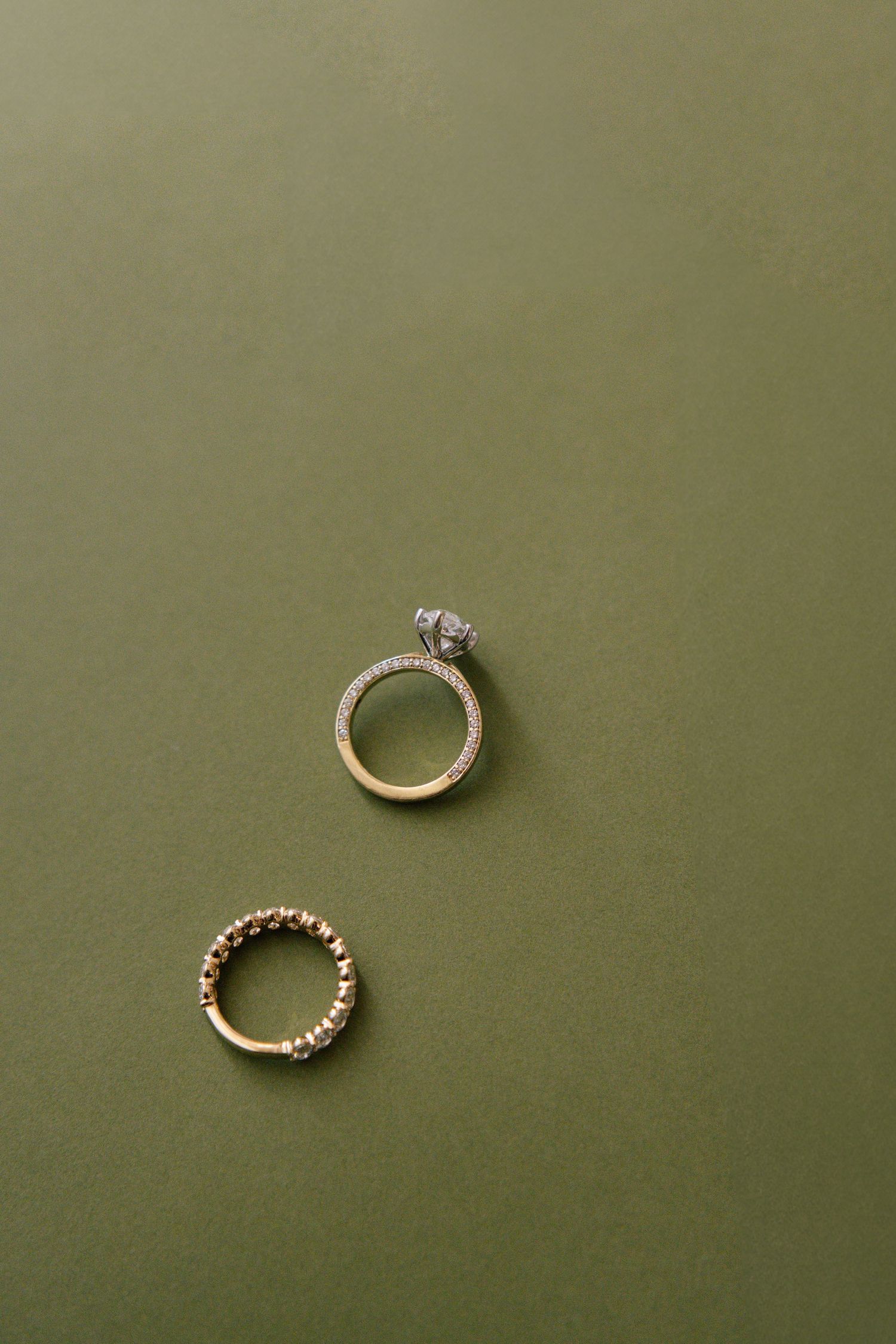Wedding rings displayed in a sequence on a sage green background showing different angles and details.