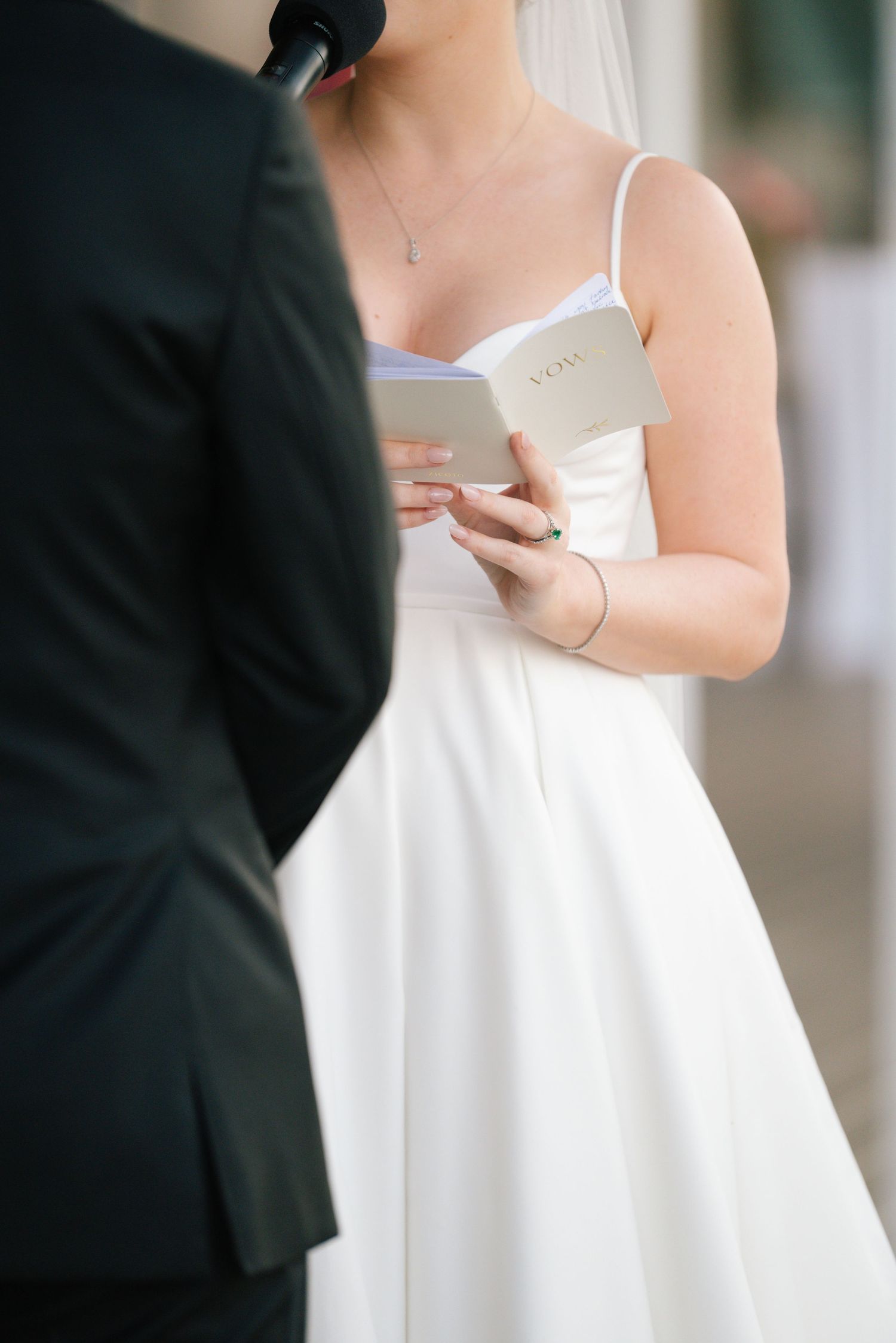 Close-up details of white wedding dress bodice and fabric.
