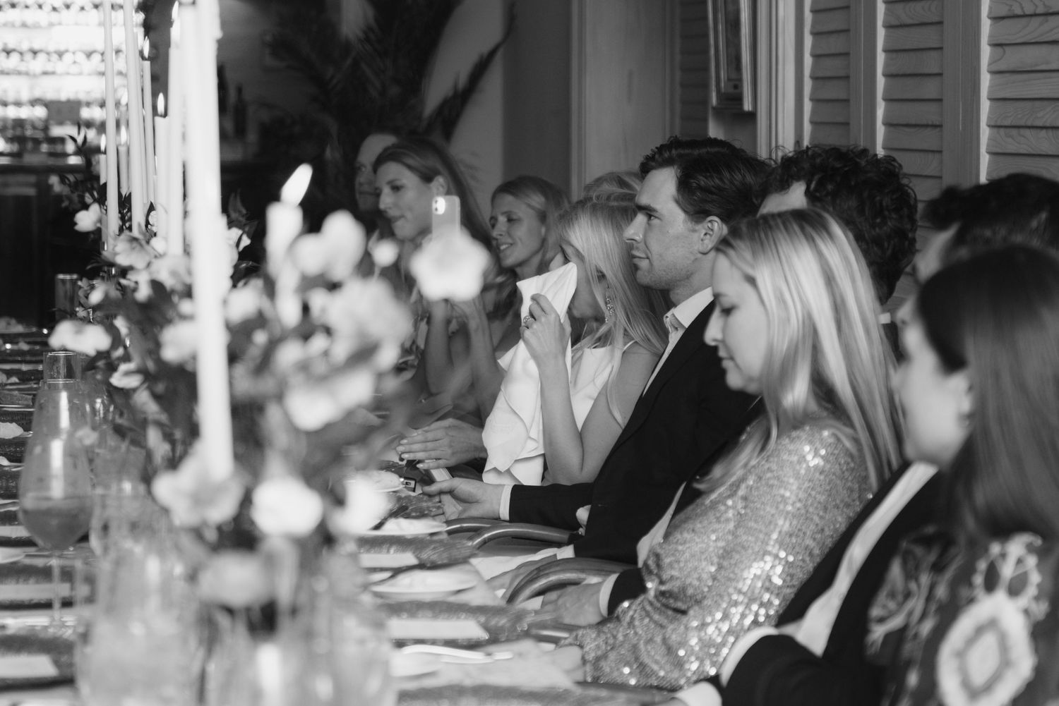 A black and white photo montage shows people seated at tables during what appears to be a wedding reception.