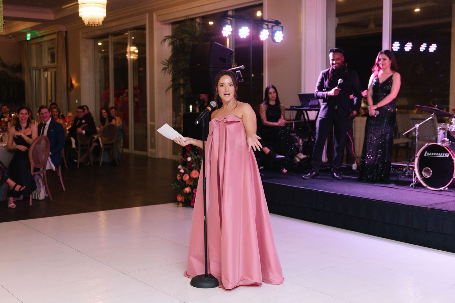 Wedding reception entertainment with stage lighting and dance floor setup.