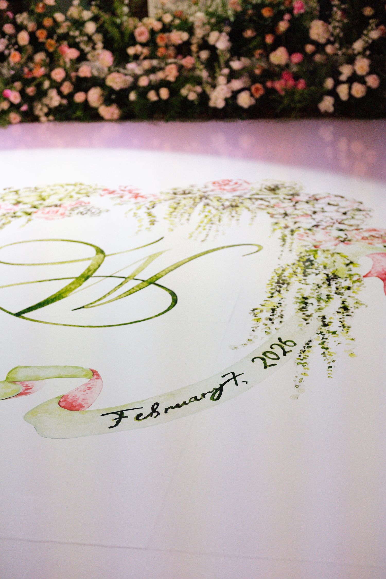 Delicate watercolor calligraphy with floral designs on white paper.