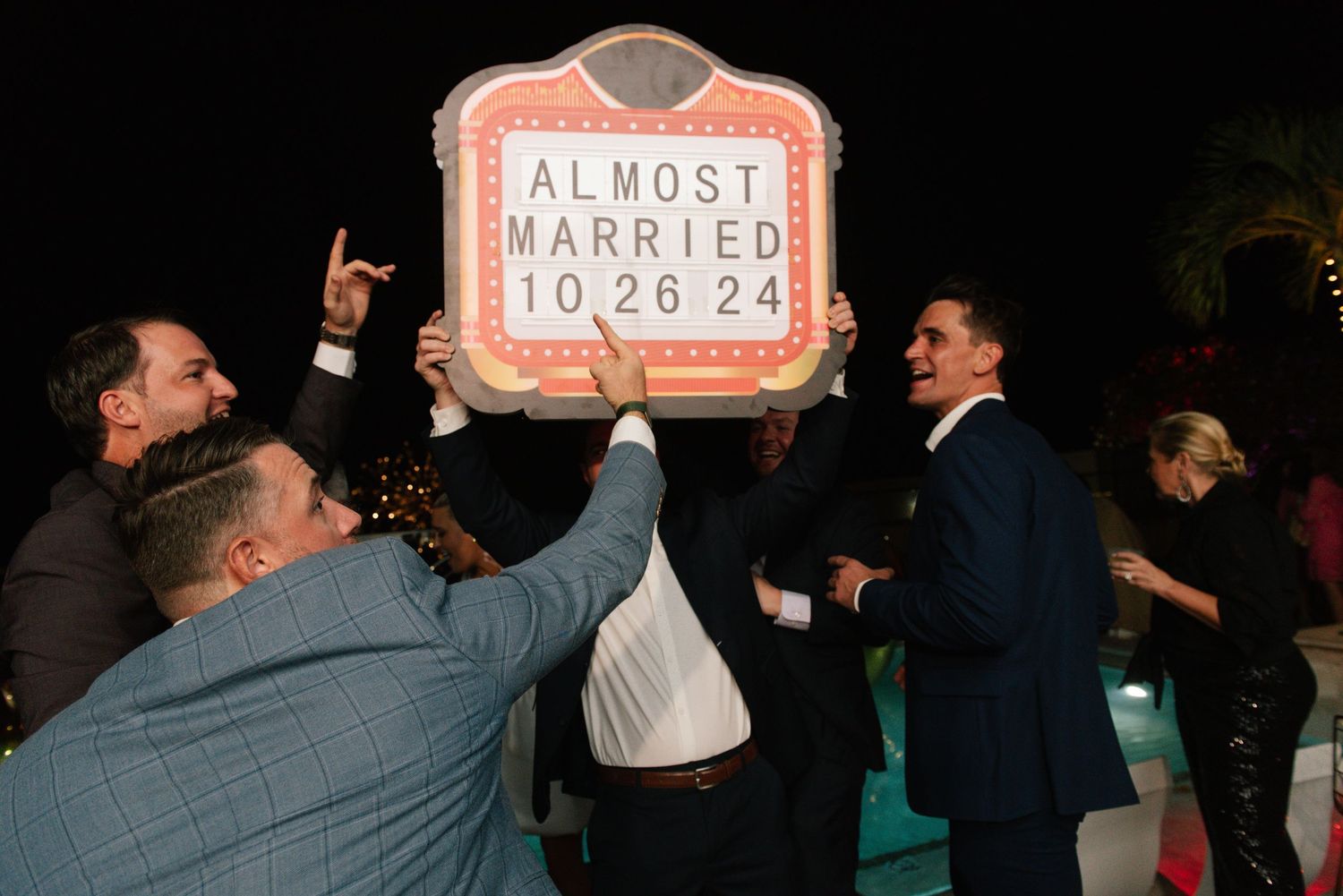 Wedding countdown sign reading 'Almost Married' displayed at an engagement celebration.