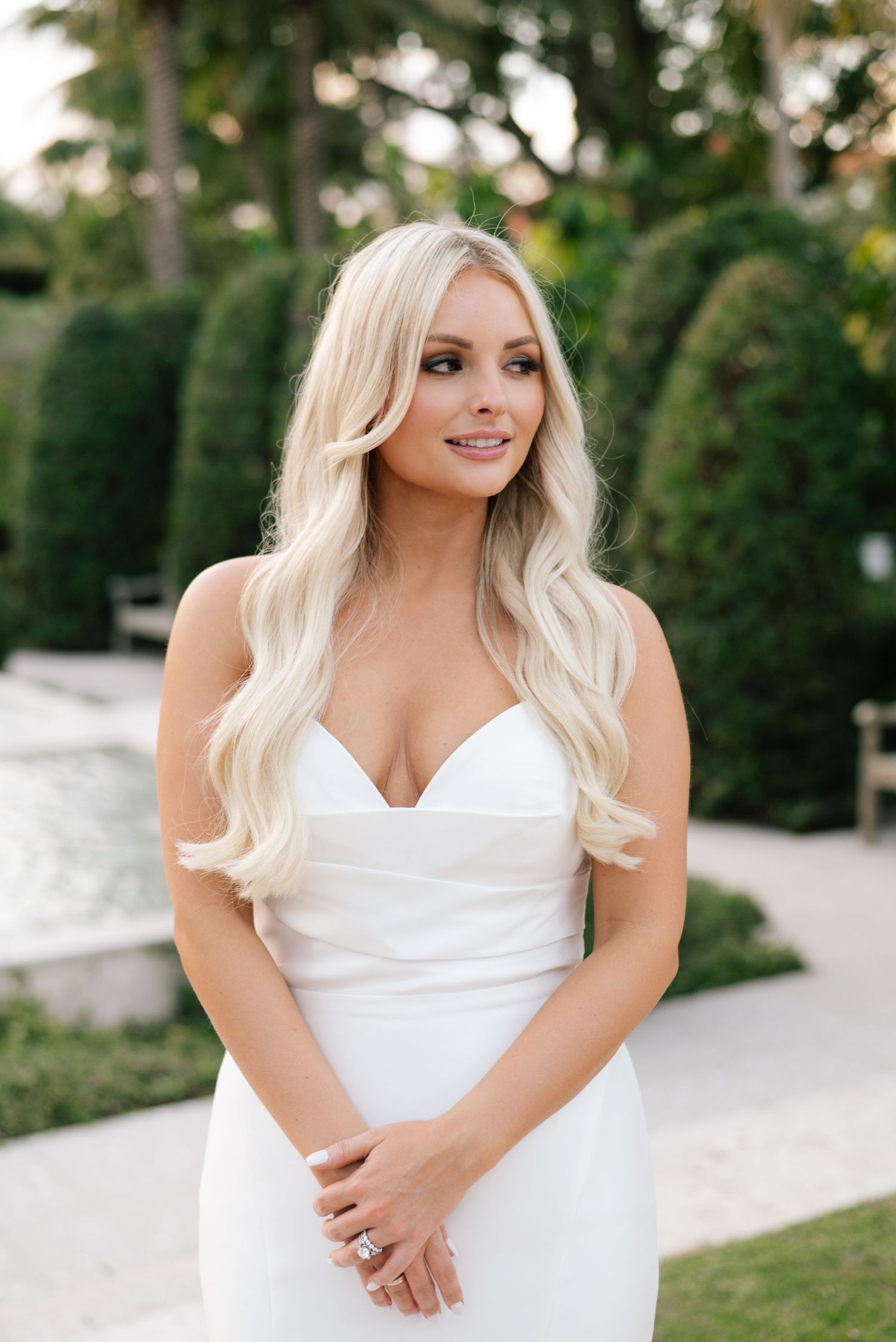 A series of outdoor portrait photos showing someone in a white dress against a garden background.