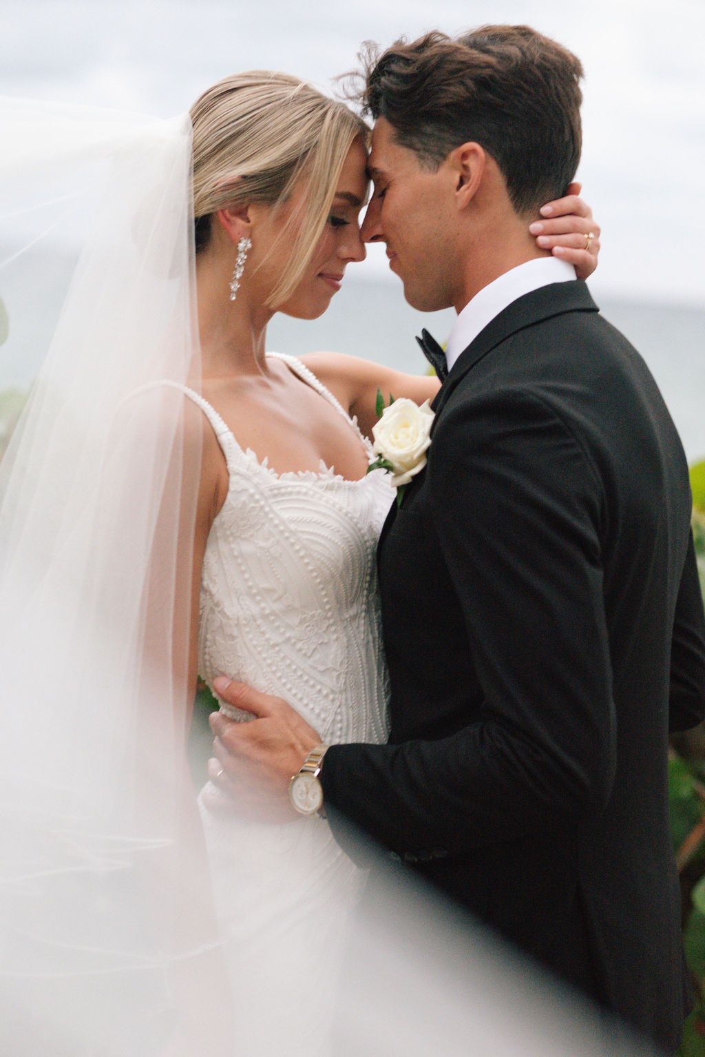 Intimate wedding couple moments captured with flowing veil.