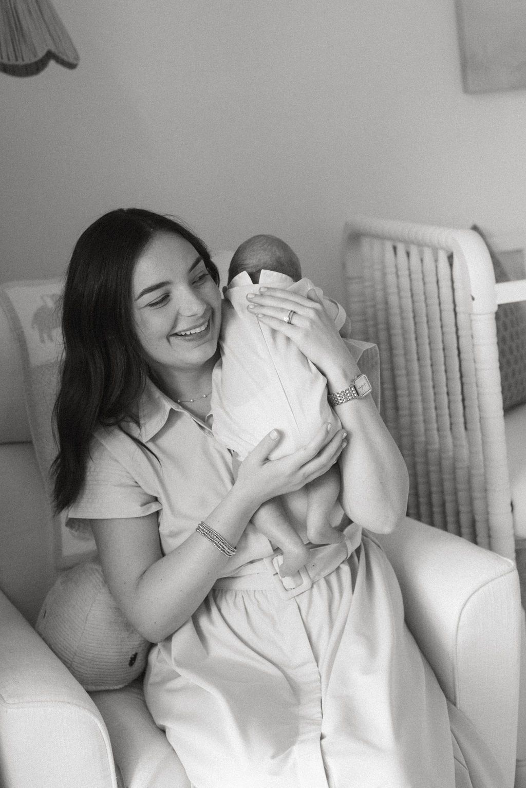 Tender moments captured in black and white photography in nursery setting.
