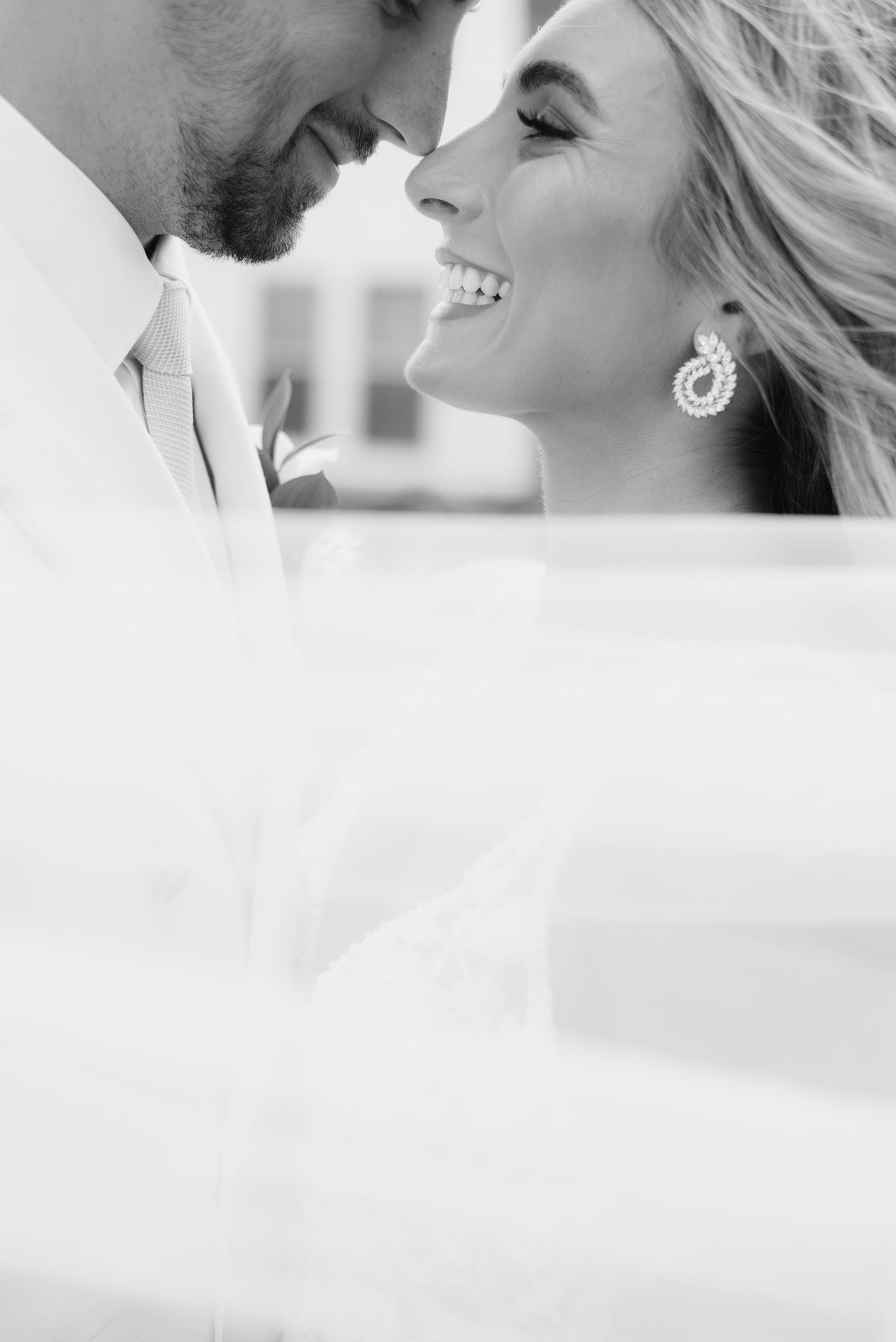 Intimate black and white close-up of a romantic wedding moment.