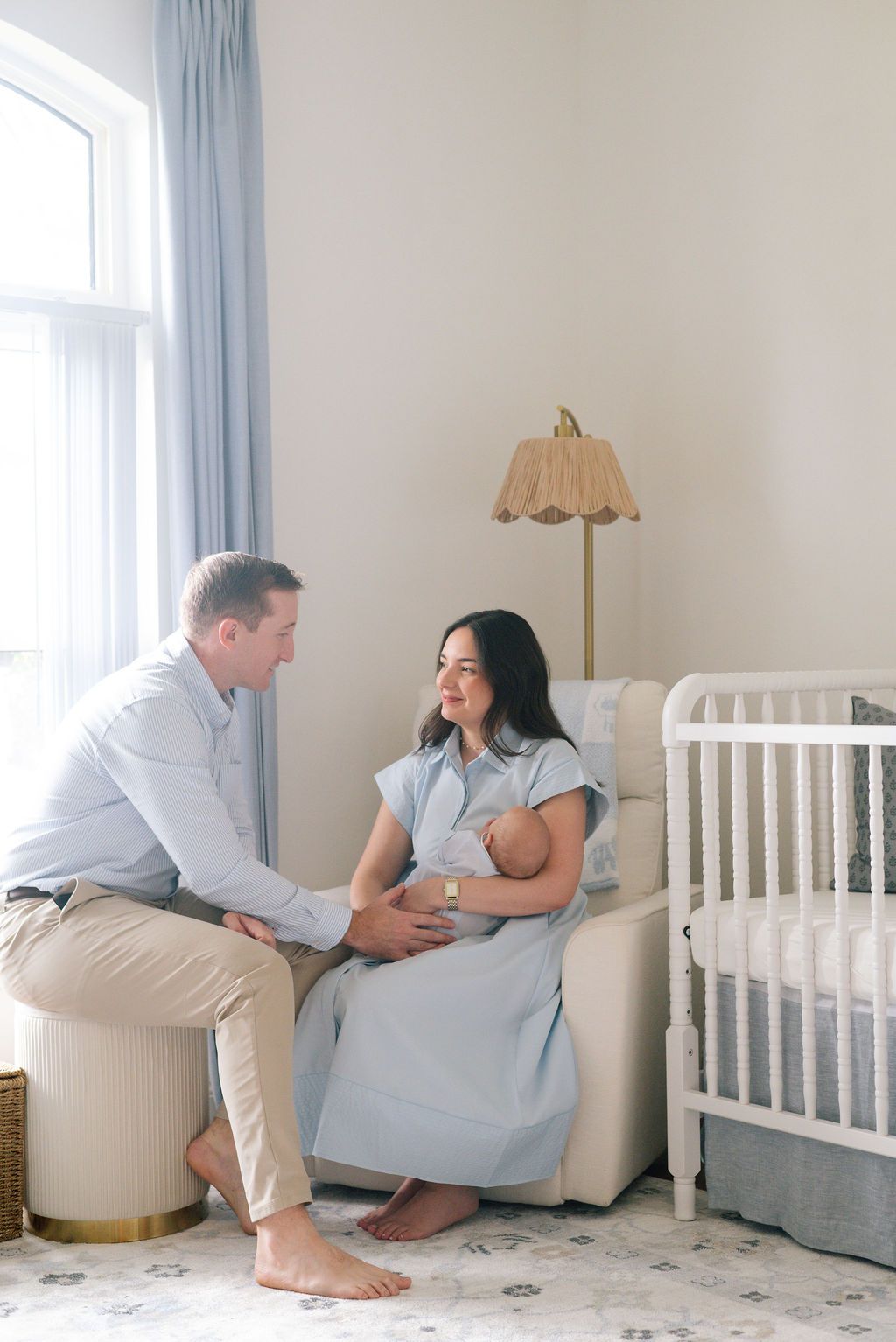 Intimate family moments captured in a bright, modern nursery setting.