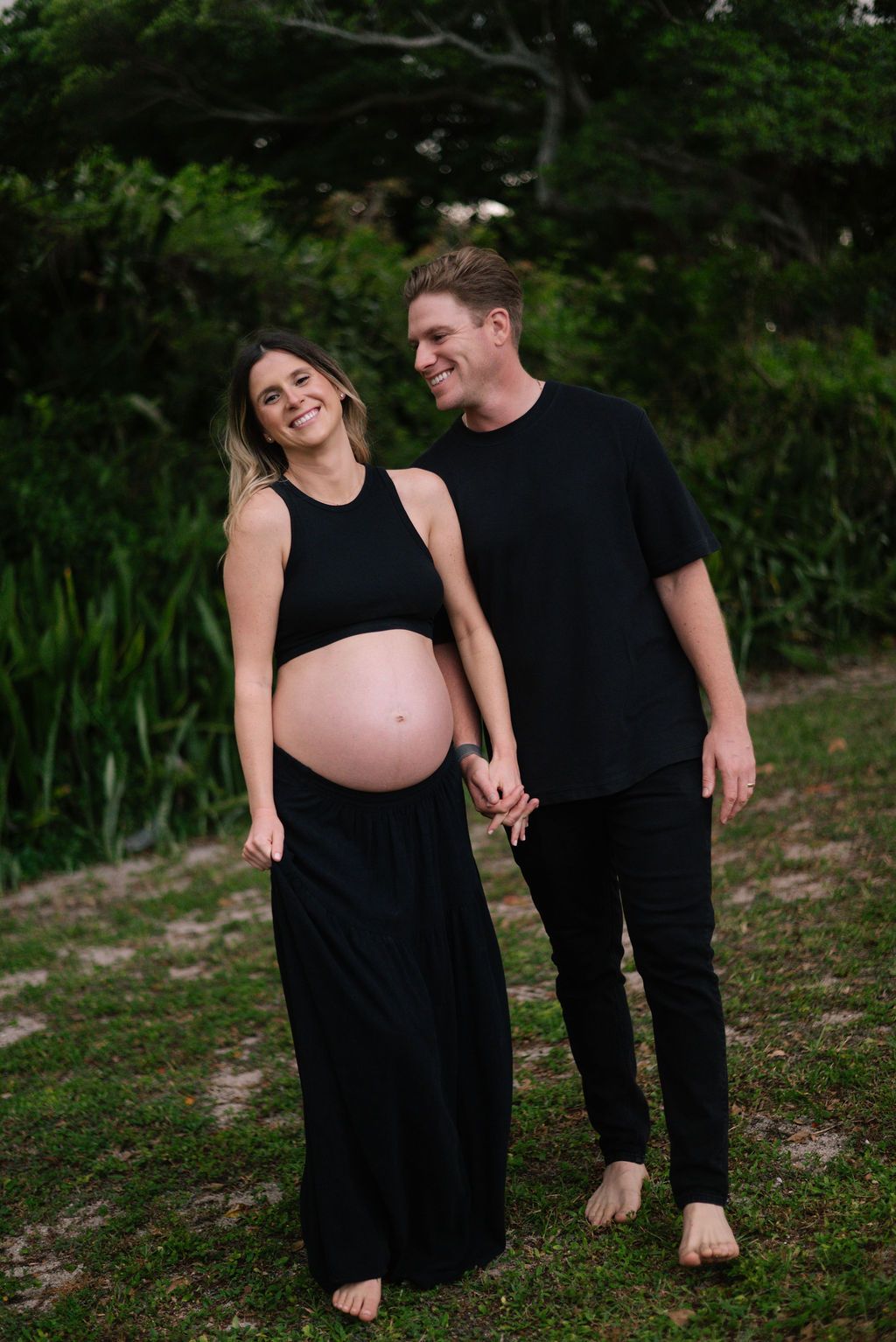 Candid maternity photography session in a natural outdoor setting.