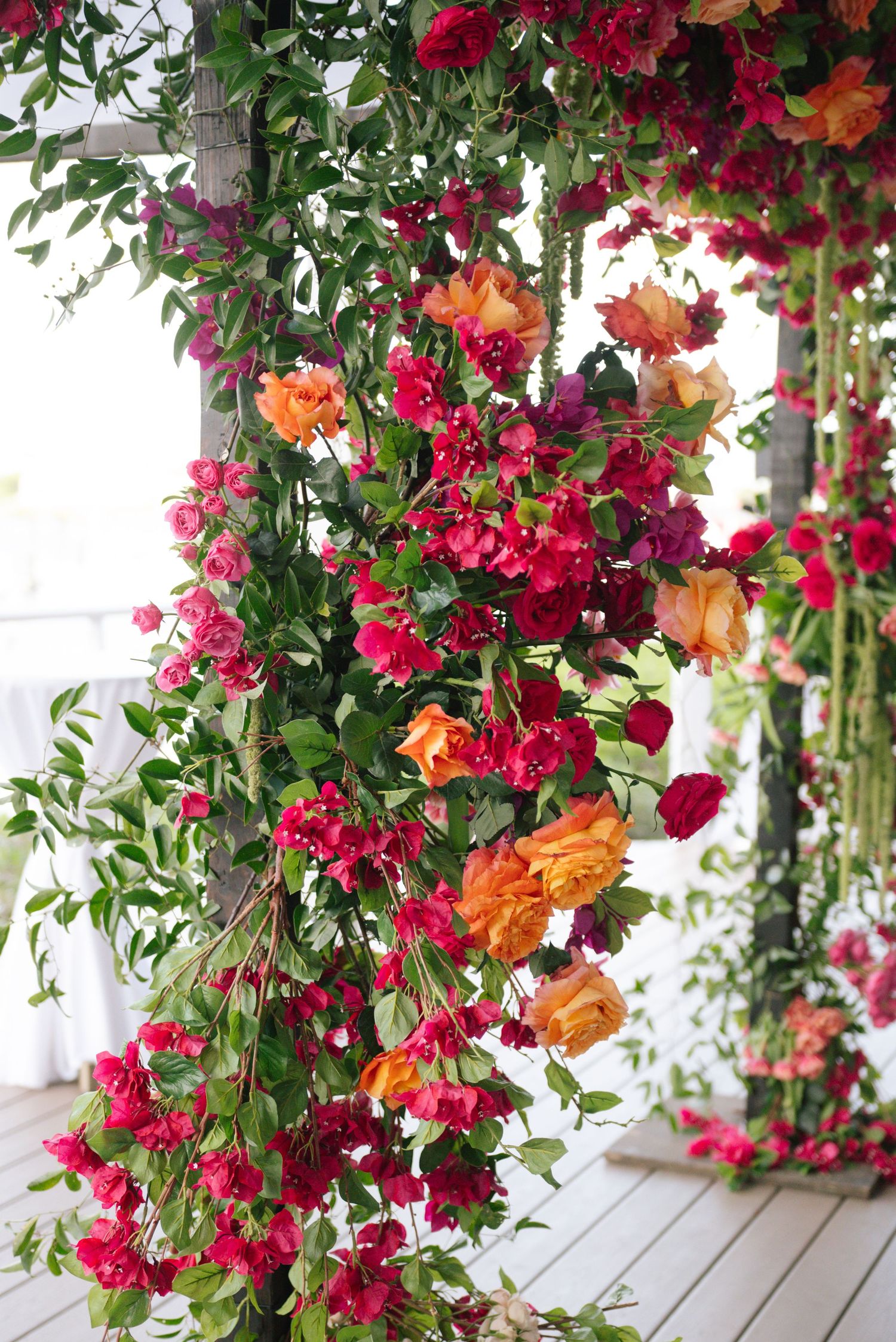 Vibrant red and orange floral arrangements cascading down decorative columns.