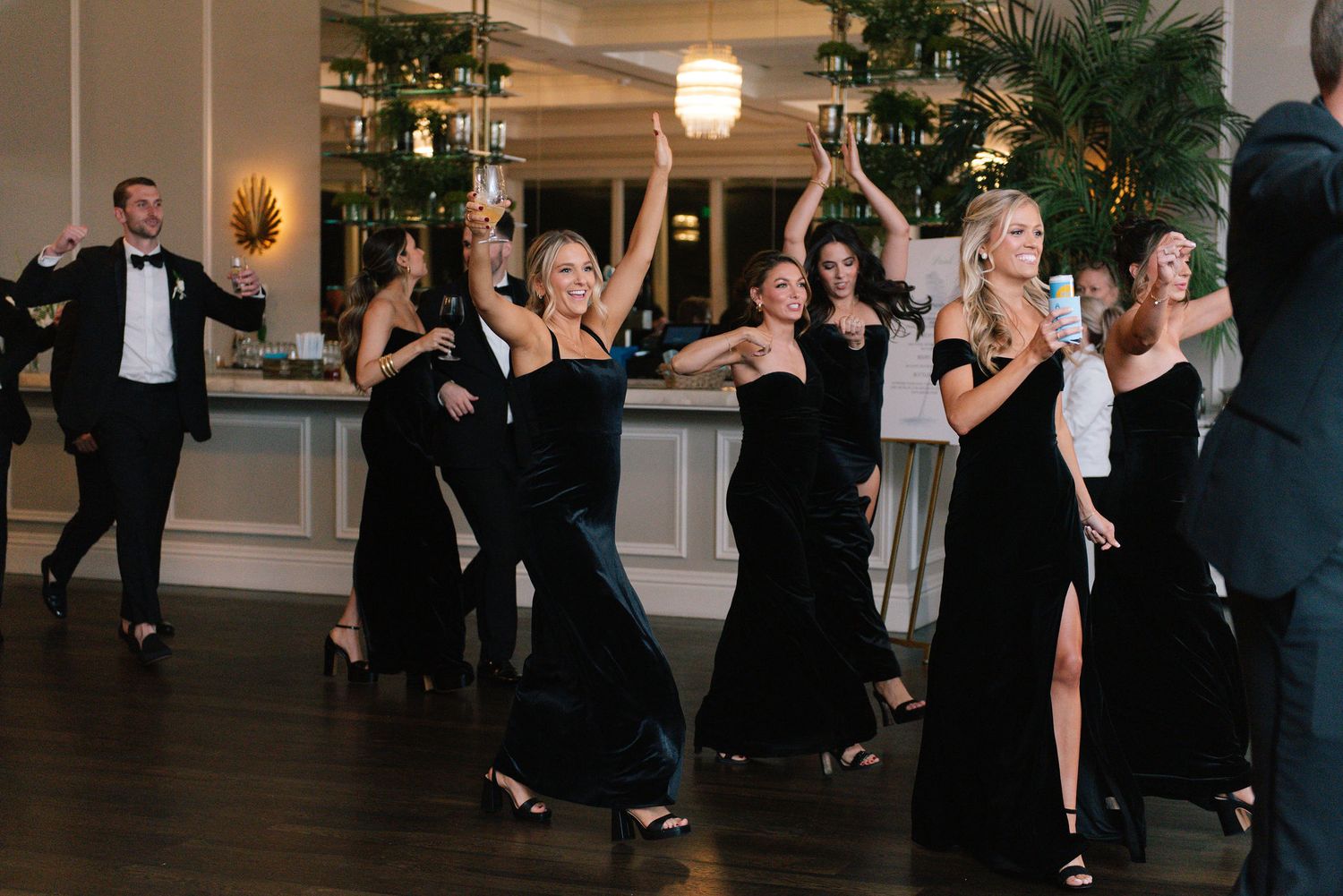 Wedding reception dance floor filled with guests celebrating.