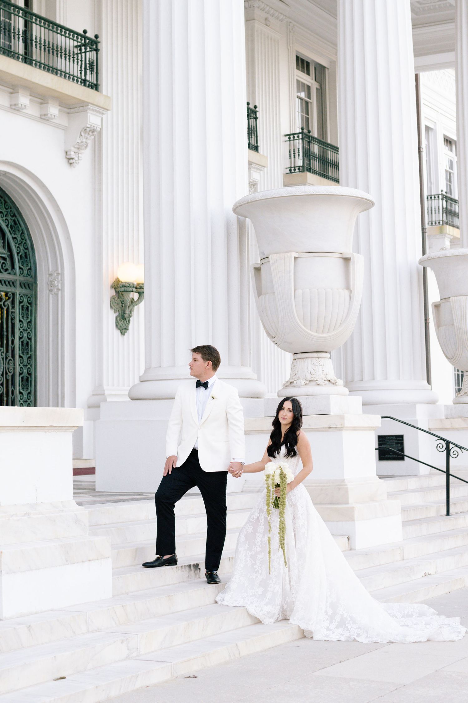 Wedding couple poses in sequence against classic white columns and ornate architecture.